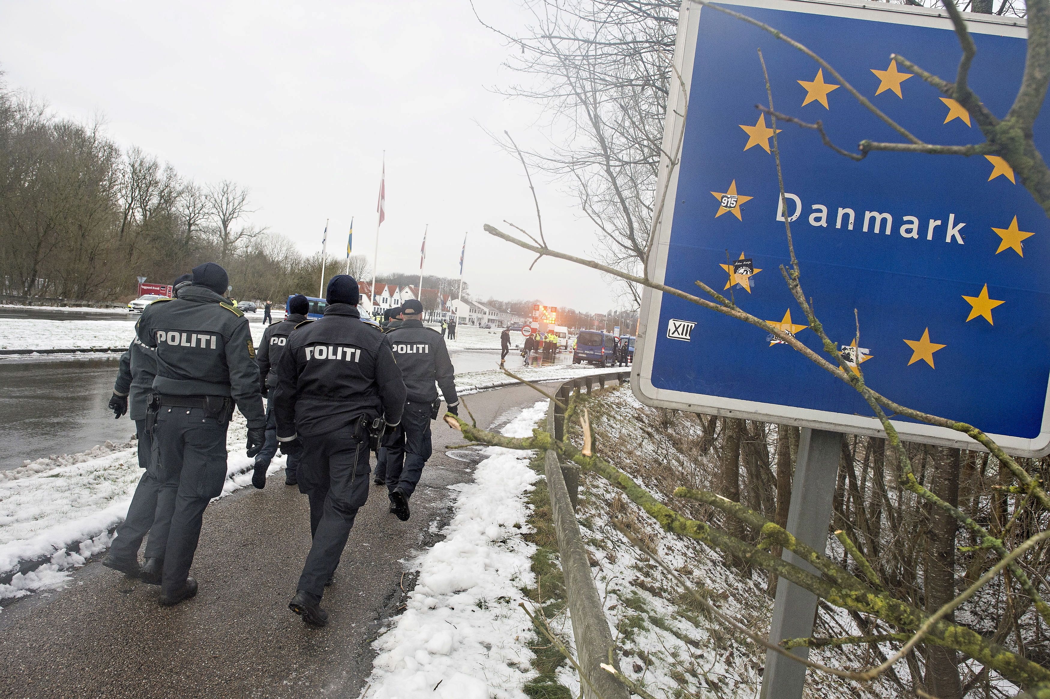 Police officers walk at the Danish-German border in Krusaa