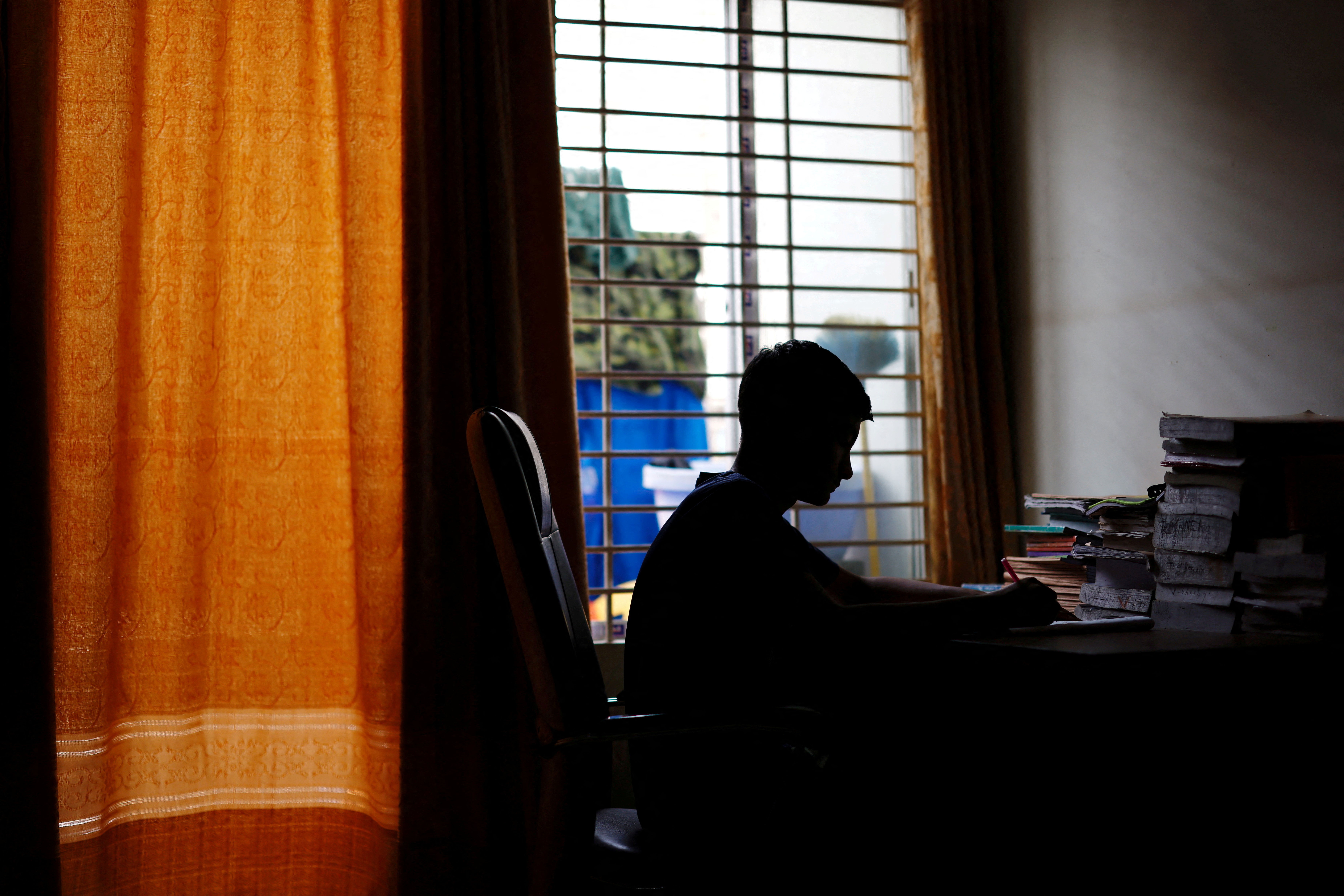 Sheikh Tamim Hasan, 13, a student of class seven, studies in his room as authorities decided to close schools during countrywide heatwave in Dhaka