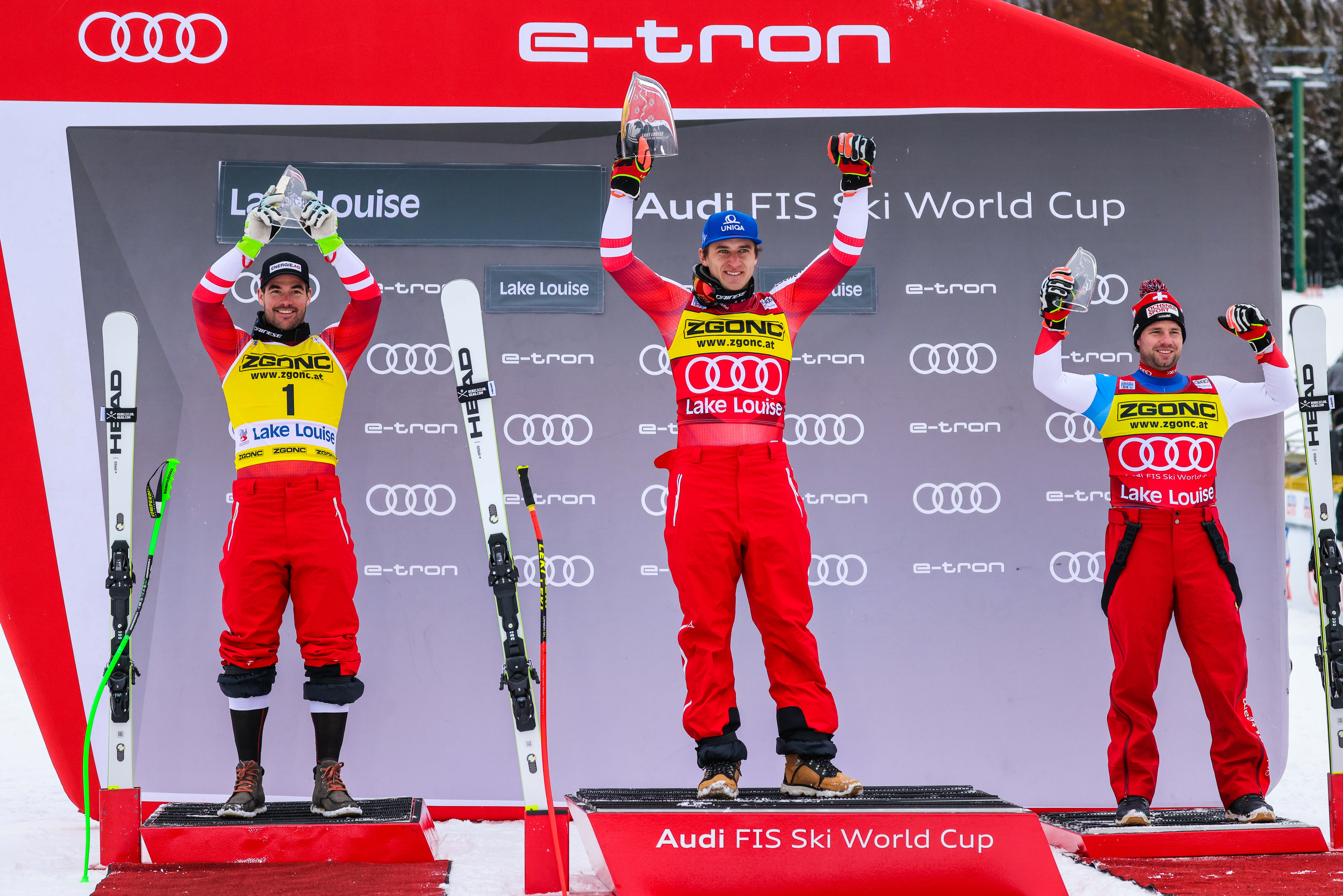 Nov 27, 2021; Lake Louise, Alberta, CAN; Vincent Kriechmayr of Austria (left) and Matthias Mayer of Austria (middle) and Beat Feuz of Switzerland (right) celebrate on the podium during men's downhill race at the FIS alpine skiing World Cup at Lake Louise. Mandatory Credit: Sergei Belski-USA TODAY Sports