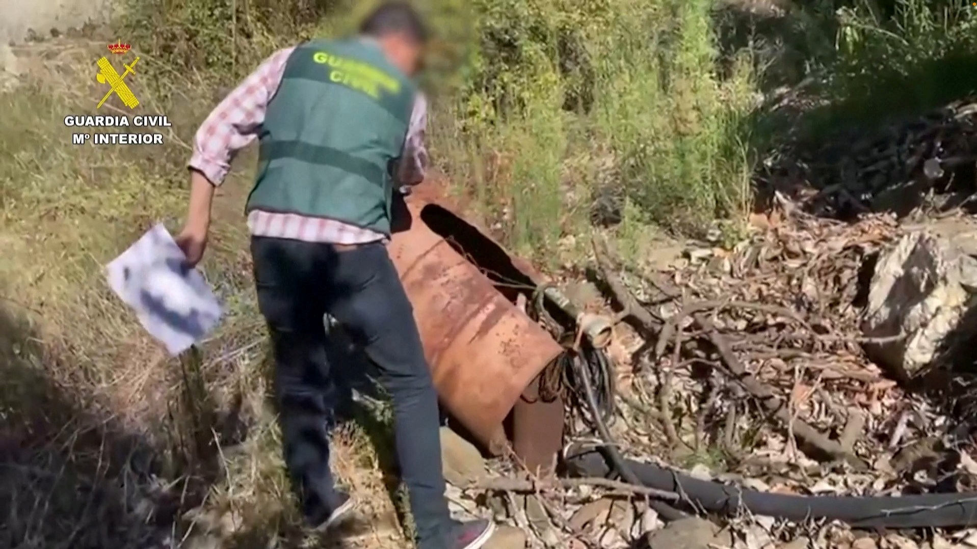 A Spanish police officer uncovers an illegal well in Malaga province
