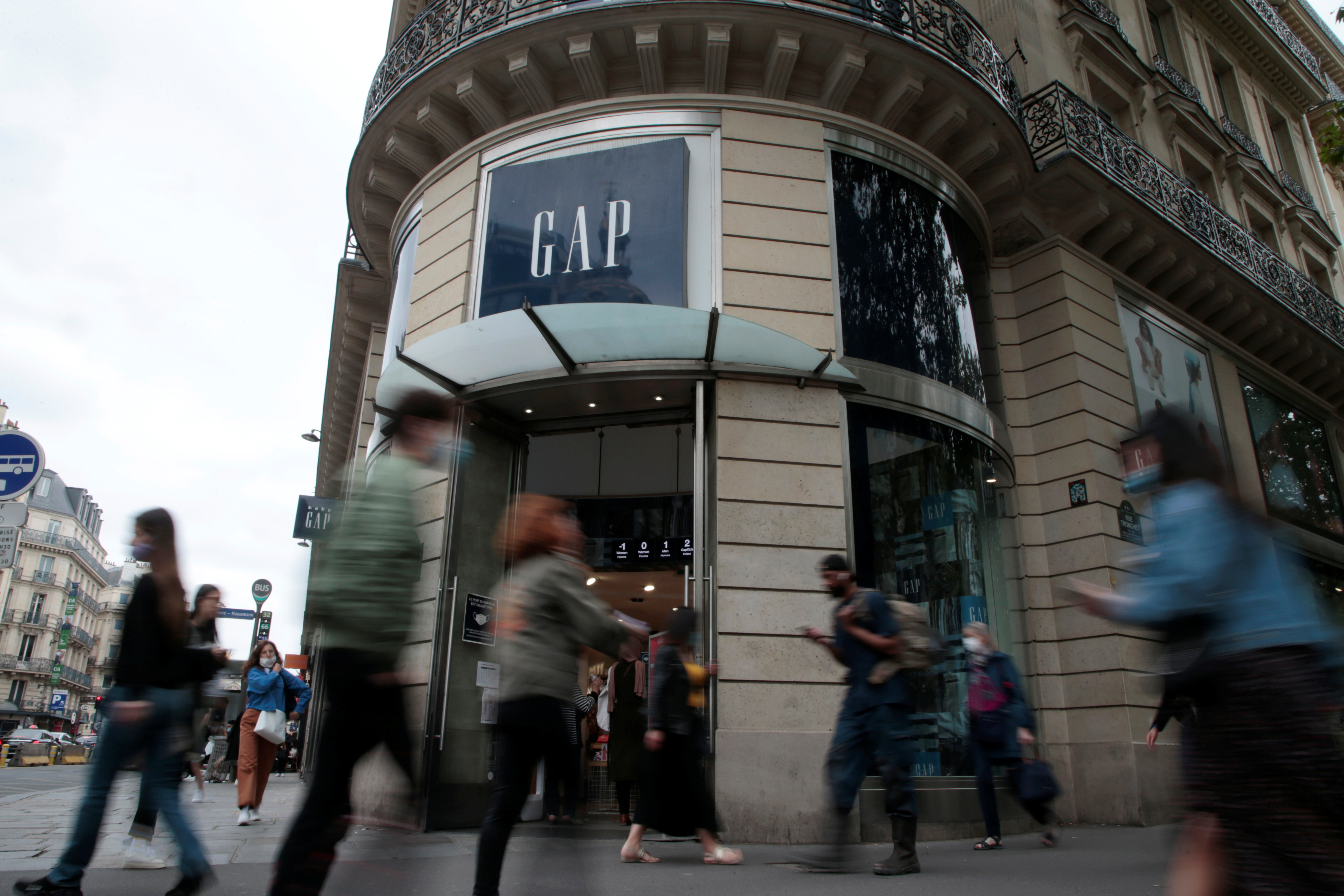 People walk past the entrance of a Gap store in Paris