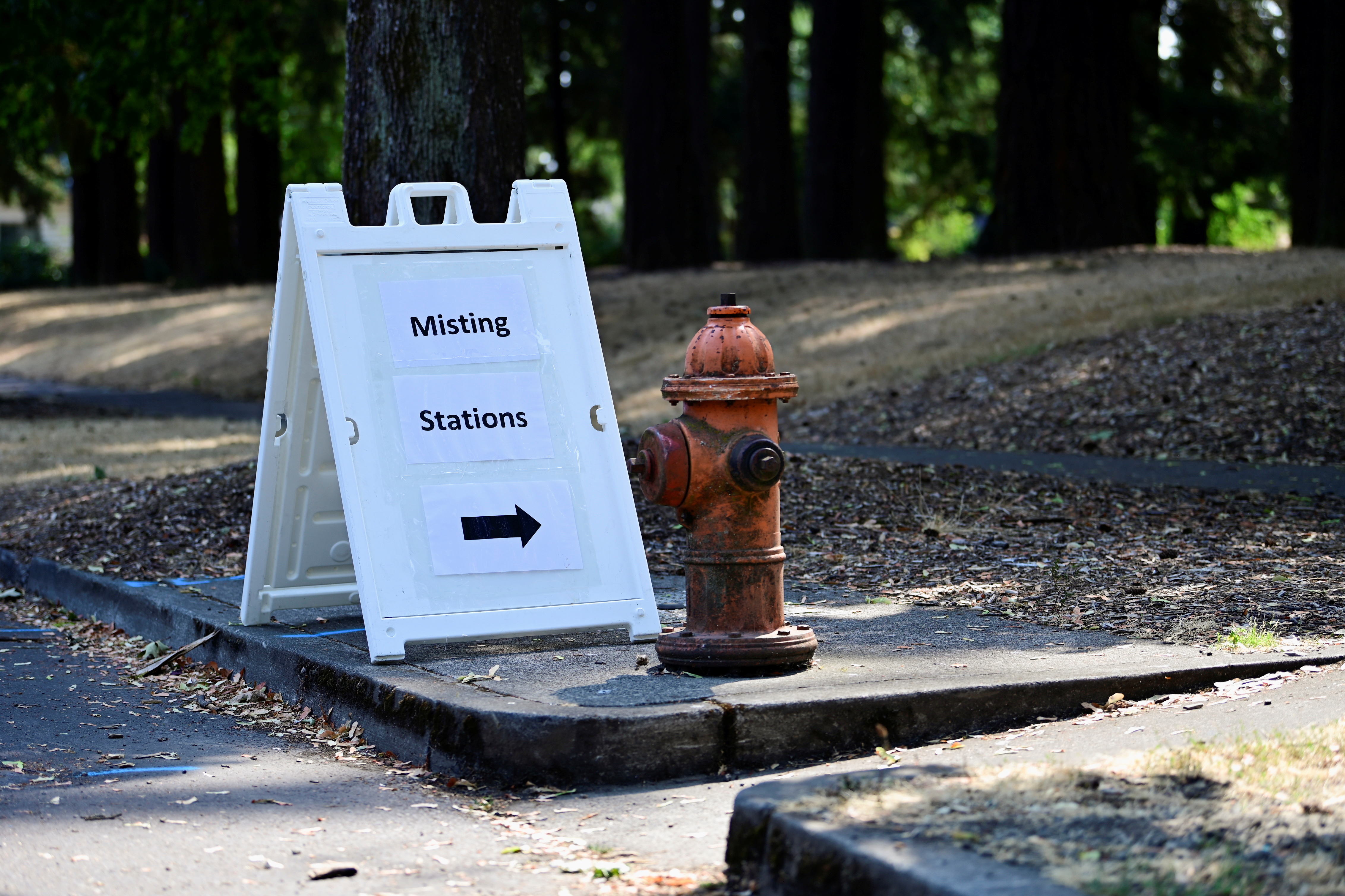 A sign sits at the entrance to Mt Scott park as a heat wave continues in Portland, Oregon, U.S., August 12, 2021.  REUTERS/Mathieu Lewis-Rolland