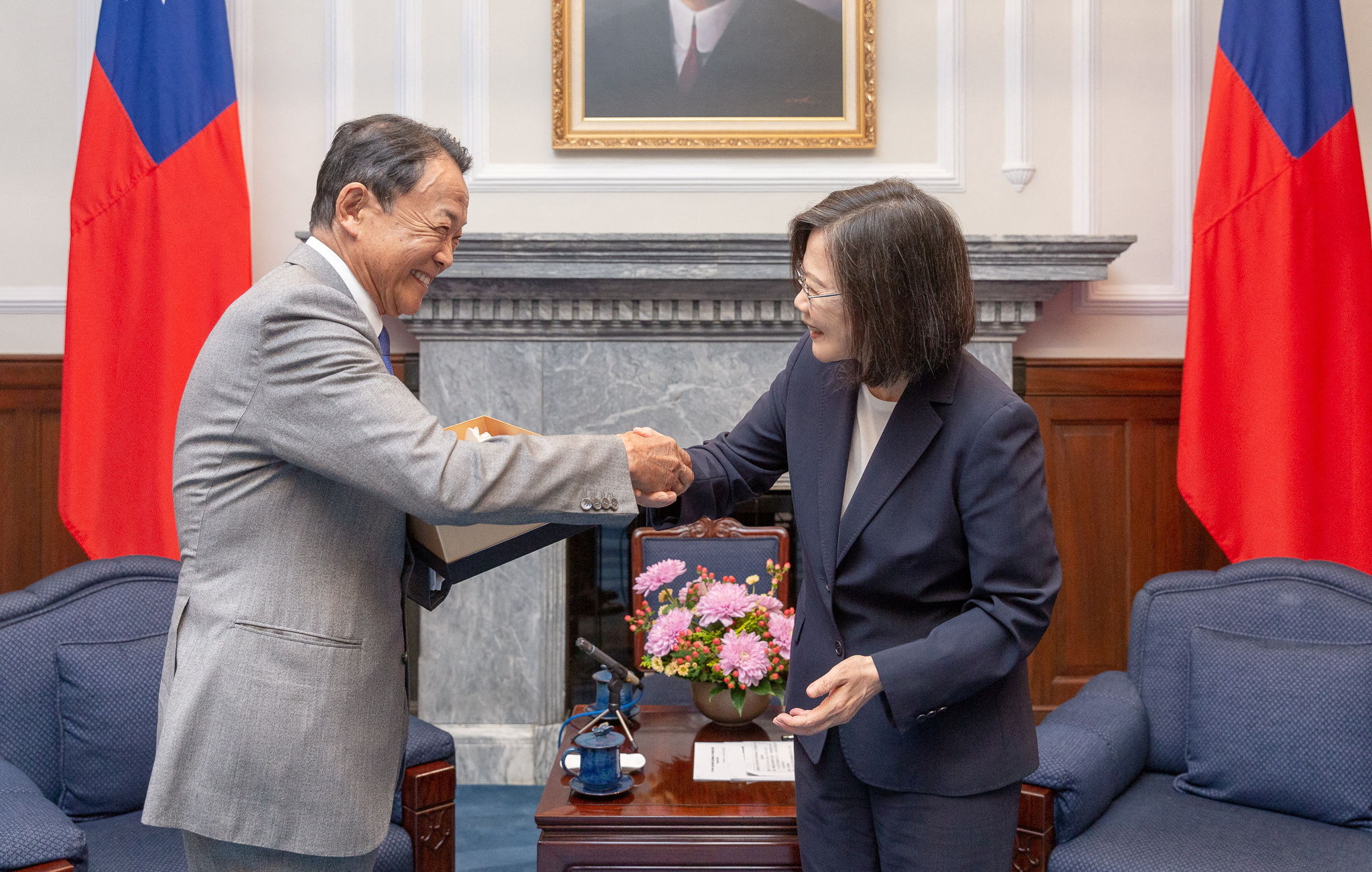 Taiwan's President Tsai Ing-wen and Japan's former prime minister and current vice-president of the ruling Liberal Democratic Party, Taro Aso, shake hands during their meeting at the presidential office in Taipei