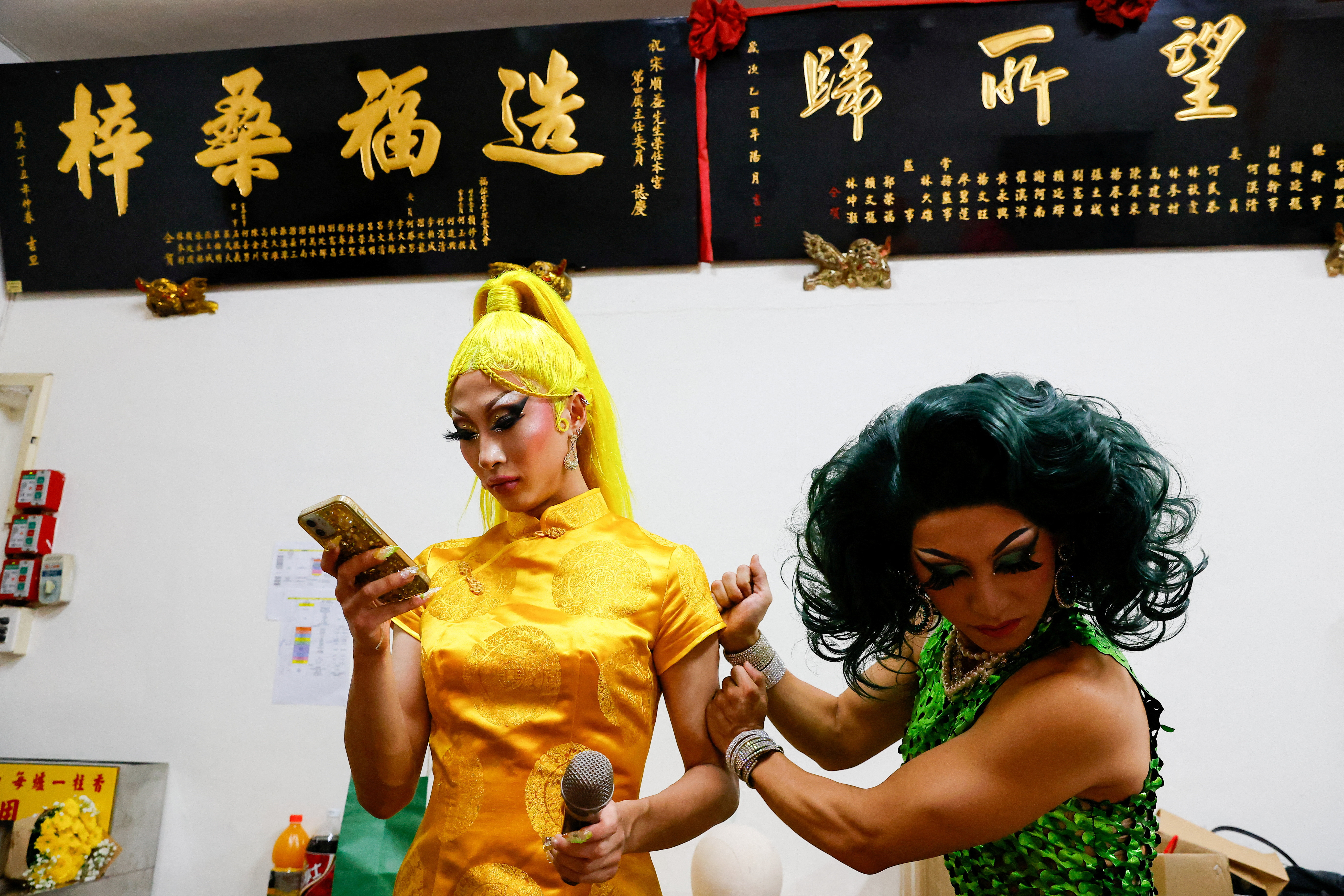 Nymphia Wind and another Taiwanese drag queen prepare before their performance at a local temple in Taipei