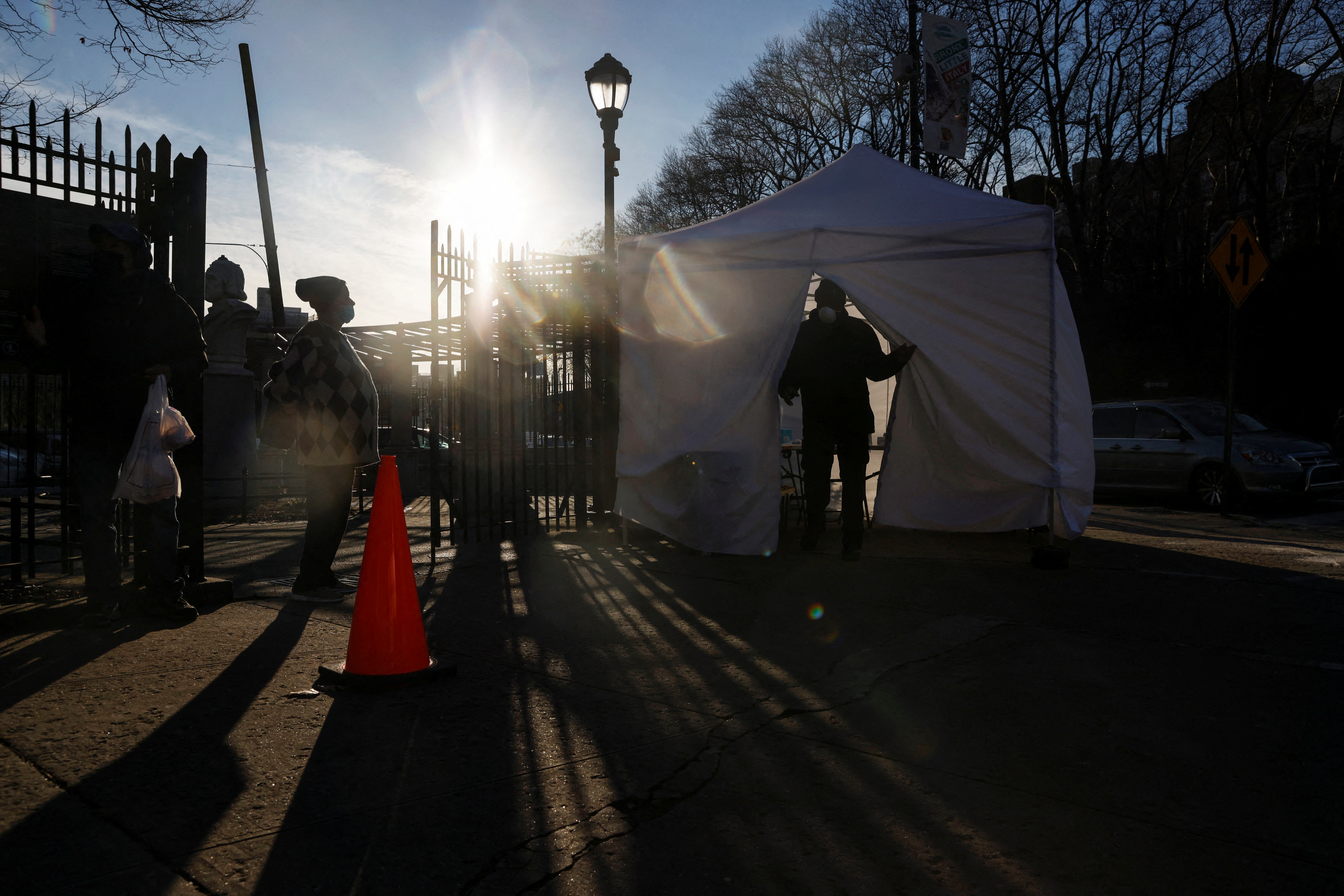 People wait in line to a coronavirus disease (COVID-19) pop-up testing site as a man leaves, in the Bronx borough of New York City, New York, U.S., January 12, 2022. REUTERS/Shannon Stapleton