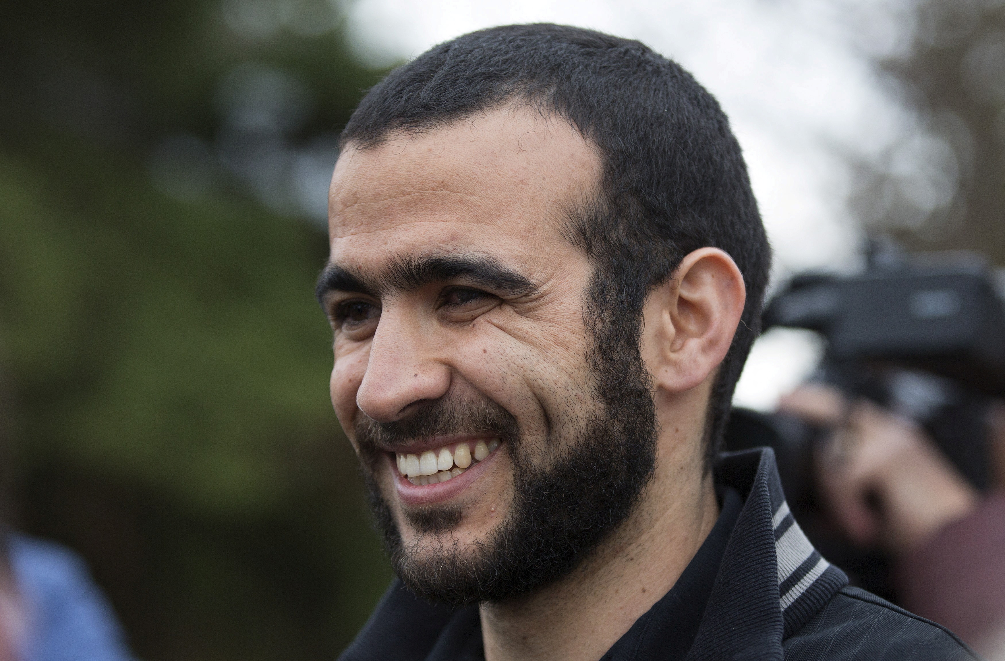 Omar Khadr smiles as he answers questions during a news conference after being released on bail in Edmonton, Alberta