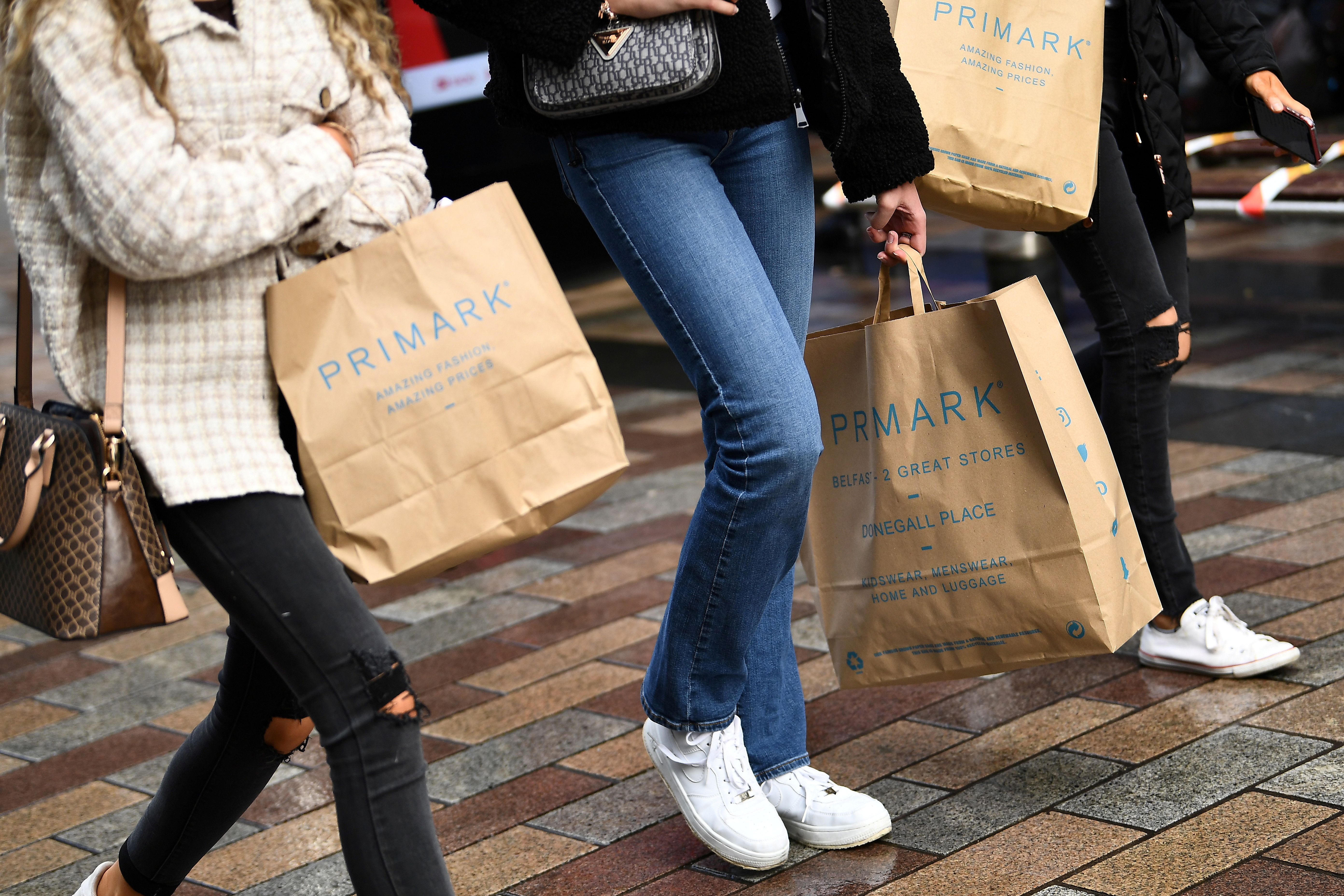 People carry Primark shopping bags after retail restrictions due to coronavirus disease (COVID-19) eased, in Belfast, Northern Ireland, May 4, 2021. REUTERS/Clodagh Kilcoyne/File Photo