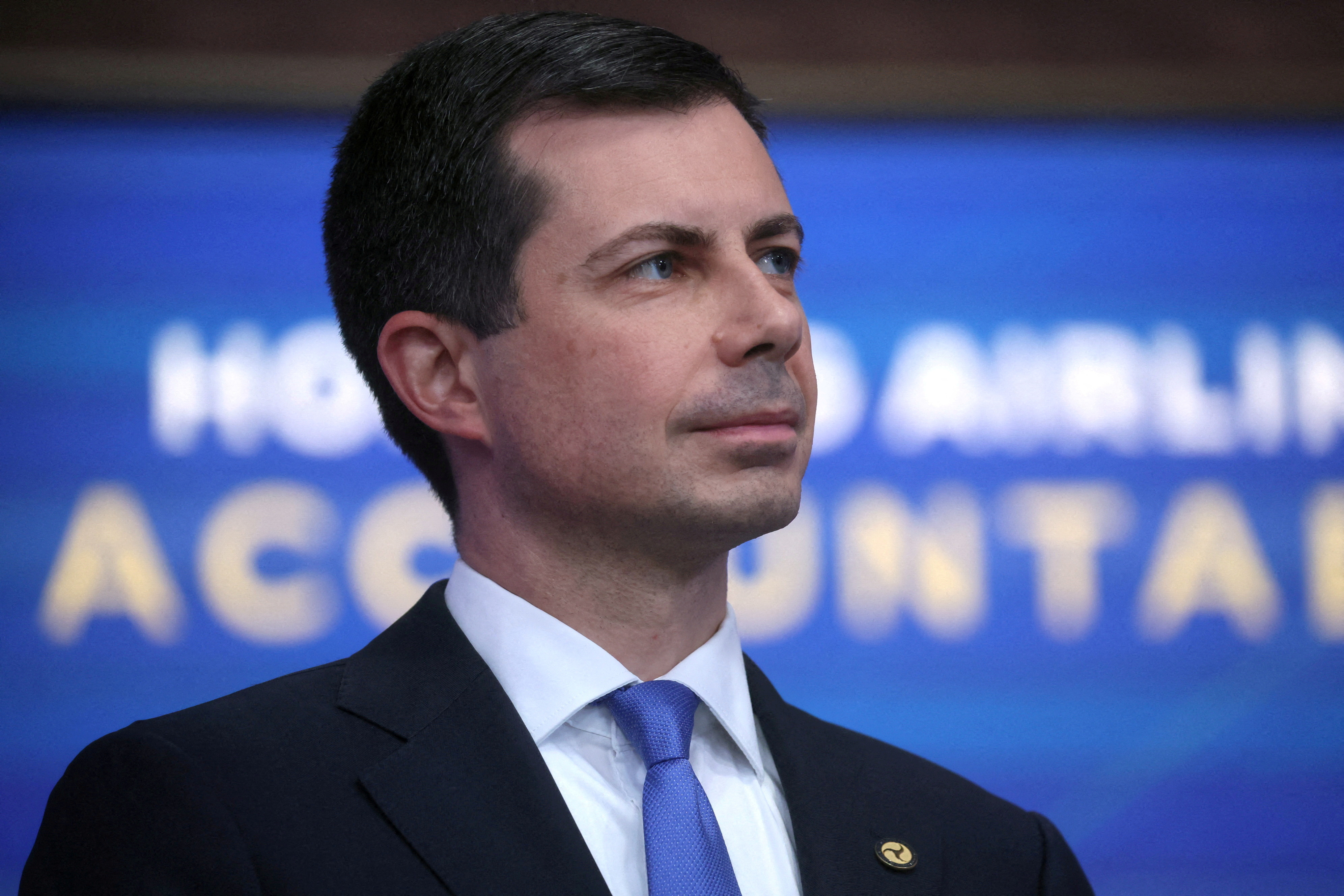 Secretary of Transportation Pete Buttigieg listens as U.S. President Biden speaks about the airline industry at the White House in Washington, U.S.