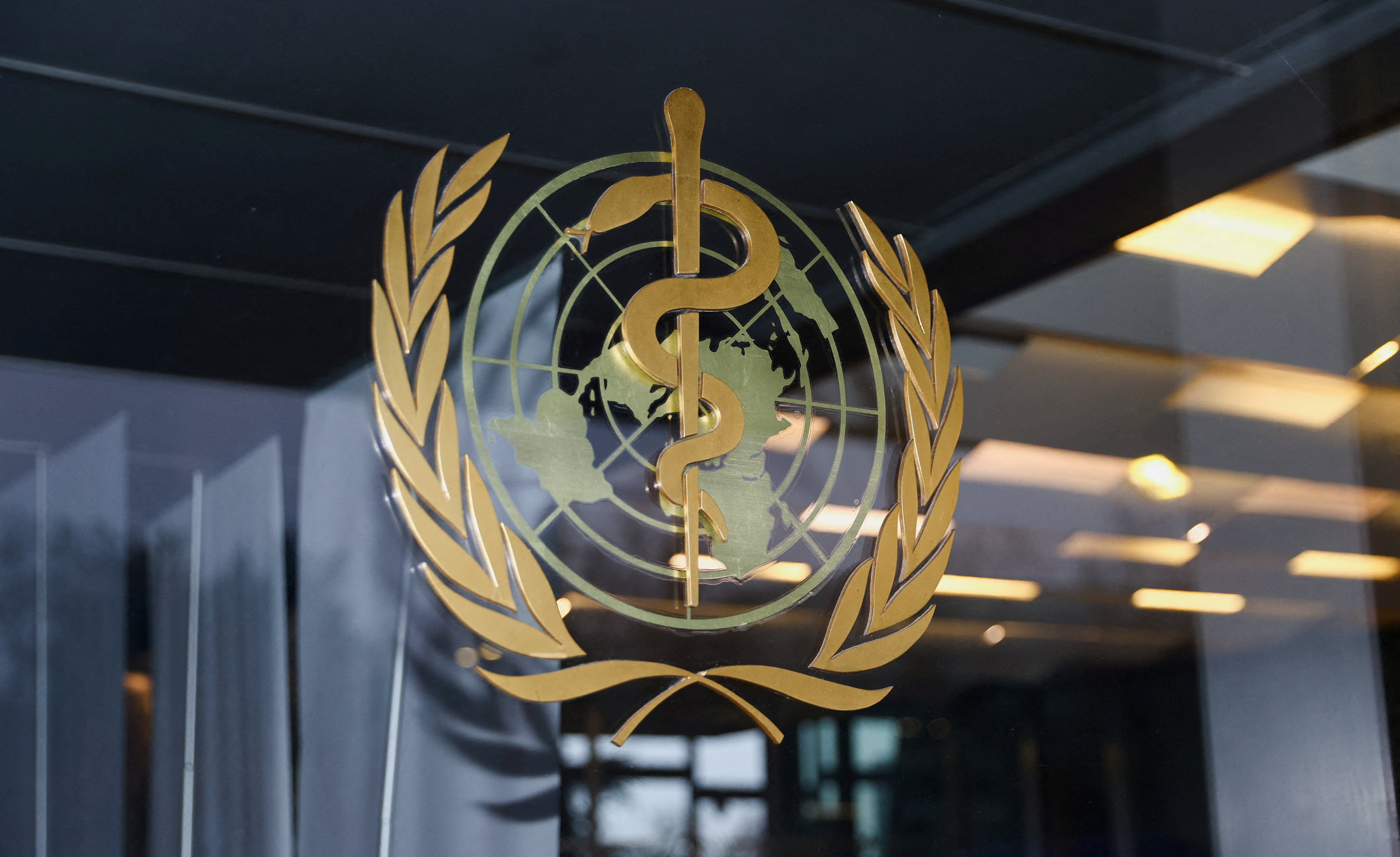 The World Health Organization logo is pictured at the entrance of the WHO building, in Geneva, Switzerland, December 20, 2021. REUTERS/Denis Balibouse
