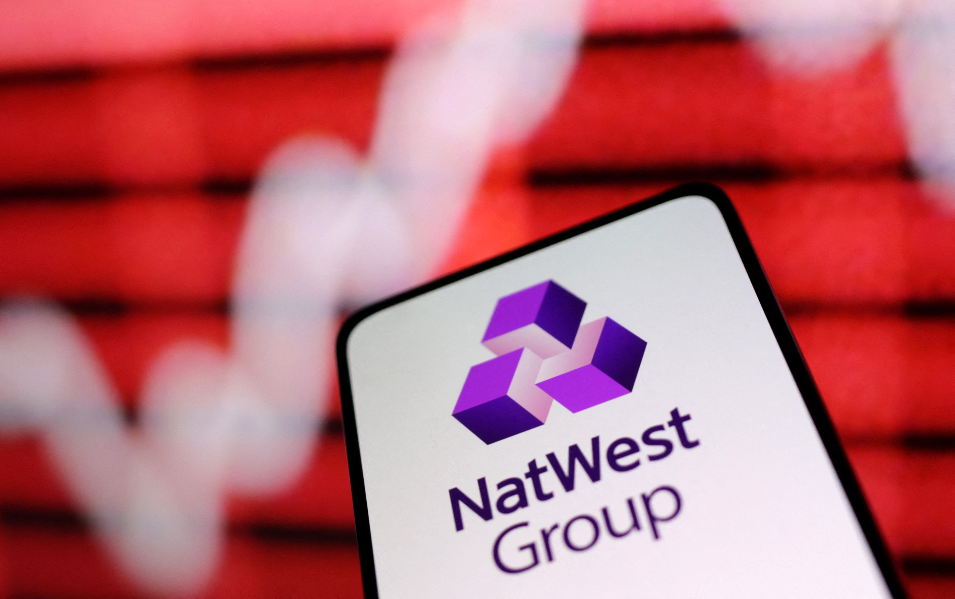 Illustration shows NatWest Group bank logo and rising stock graph