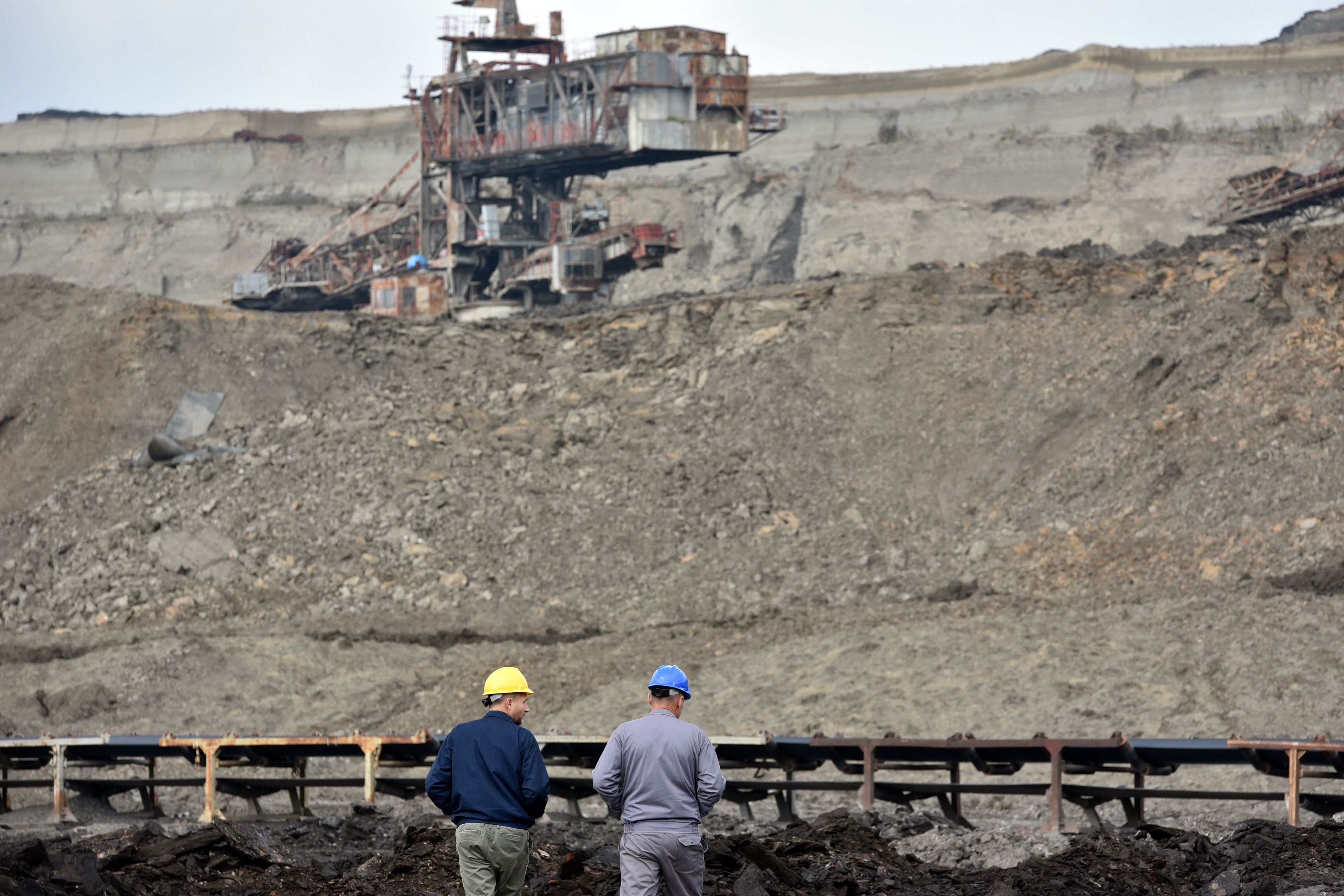 Workers walk in a lignite mine, near the town of Obiliq