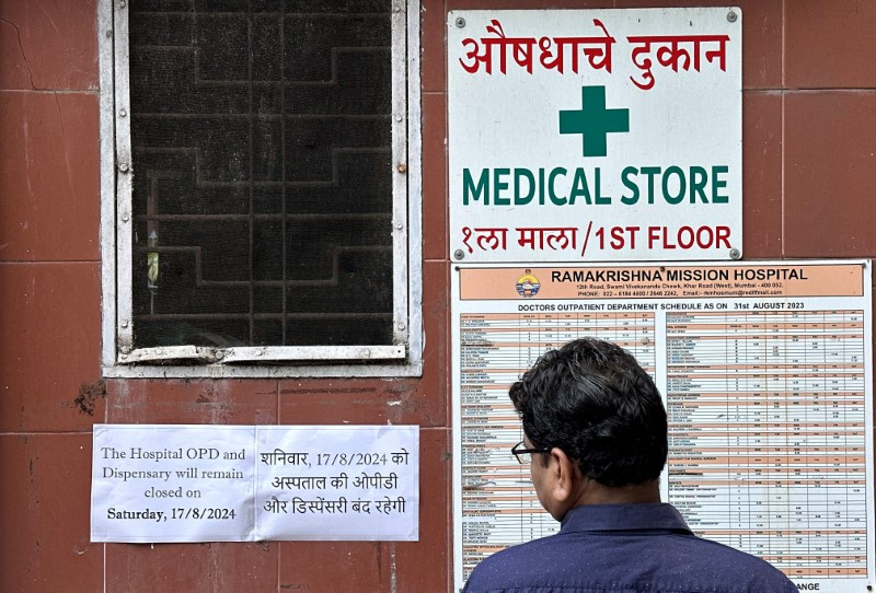 A man reads a notice at the entrance of a hospital in Mumbai