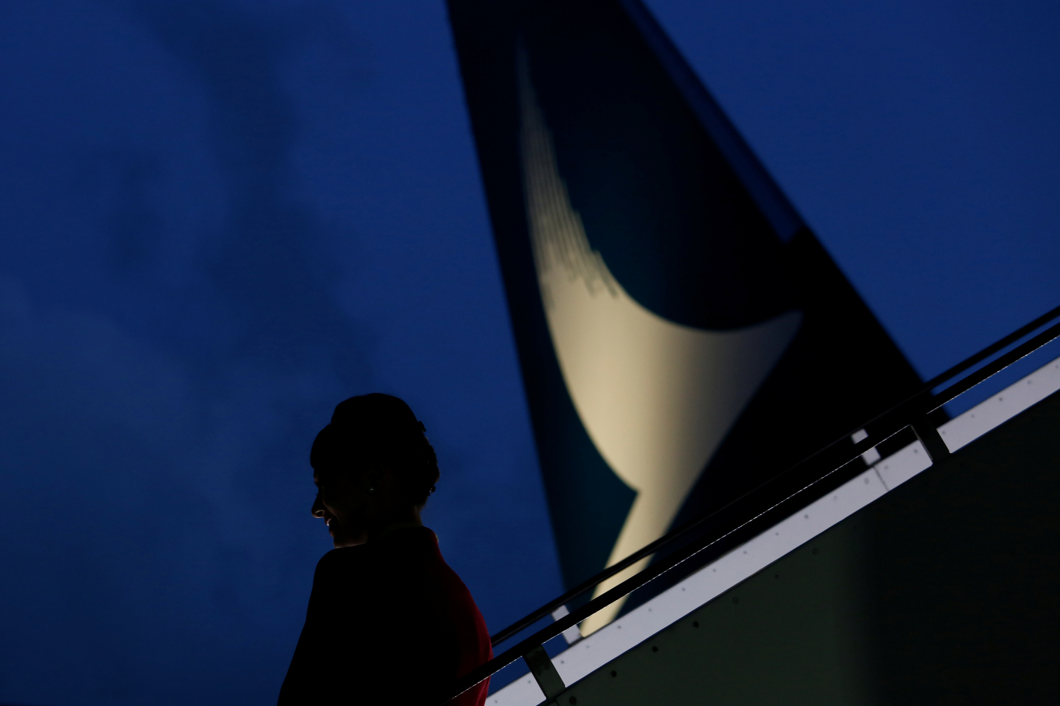 Flight attendant stands near a new Cathay Pacific Airways Airbus A350 after being received by the airline at Hong Kong Airport