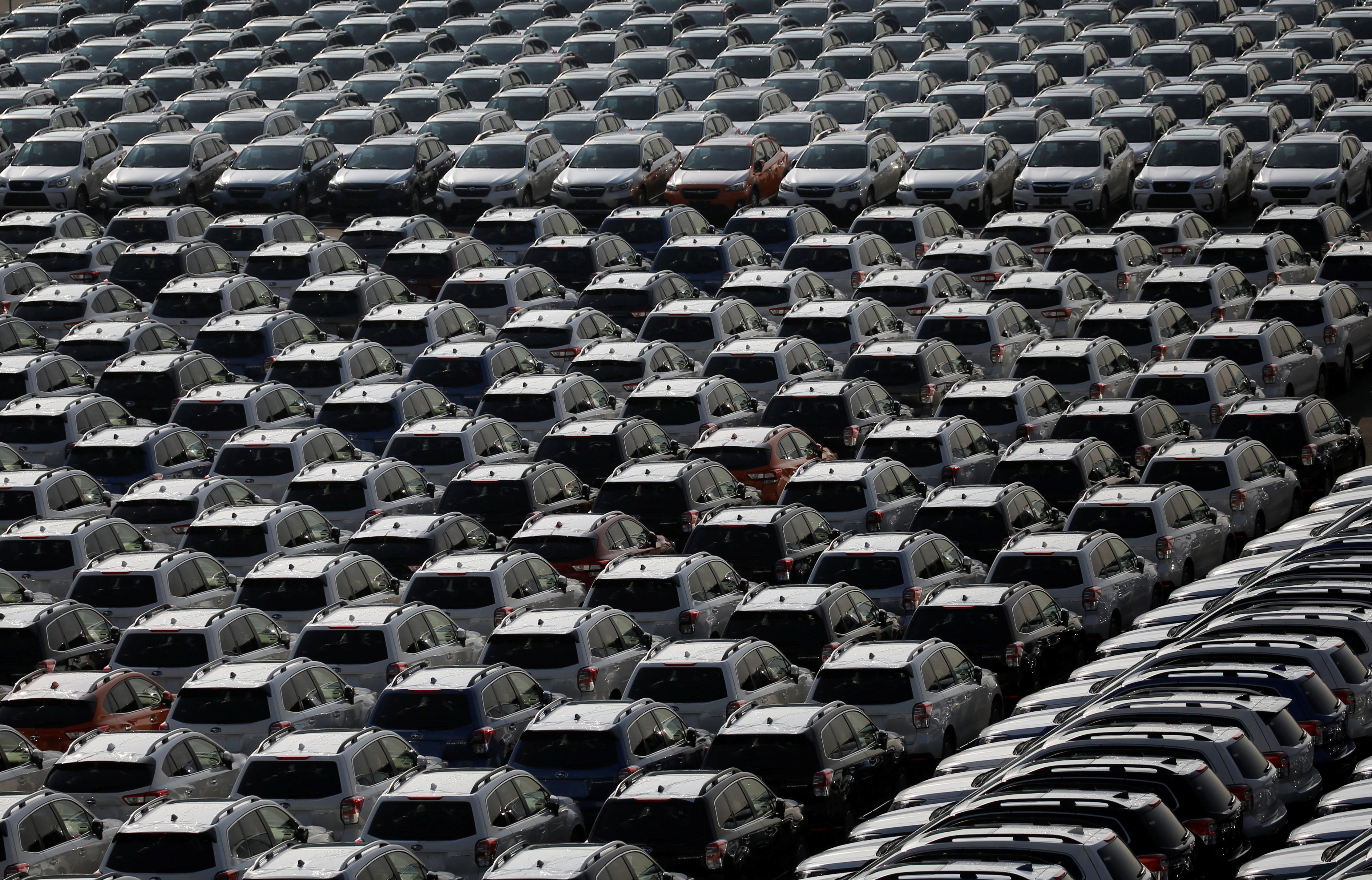 Newly manufactured cars await export at port in Yokohama