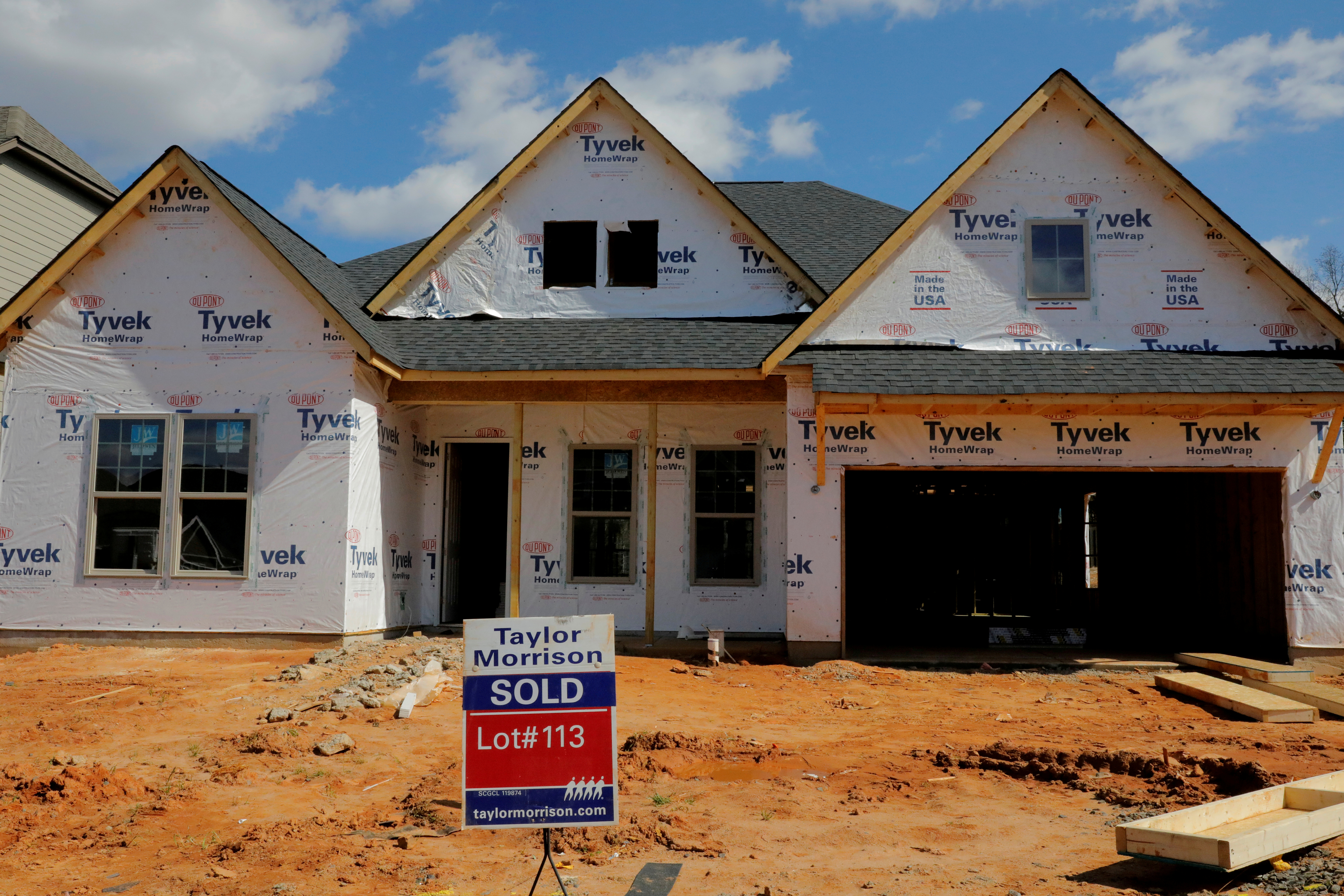 A home under construction stands behind a "sold" sign in a new development in York County, South Carolina