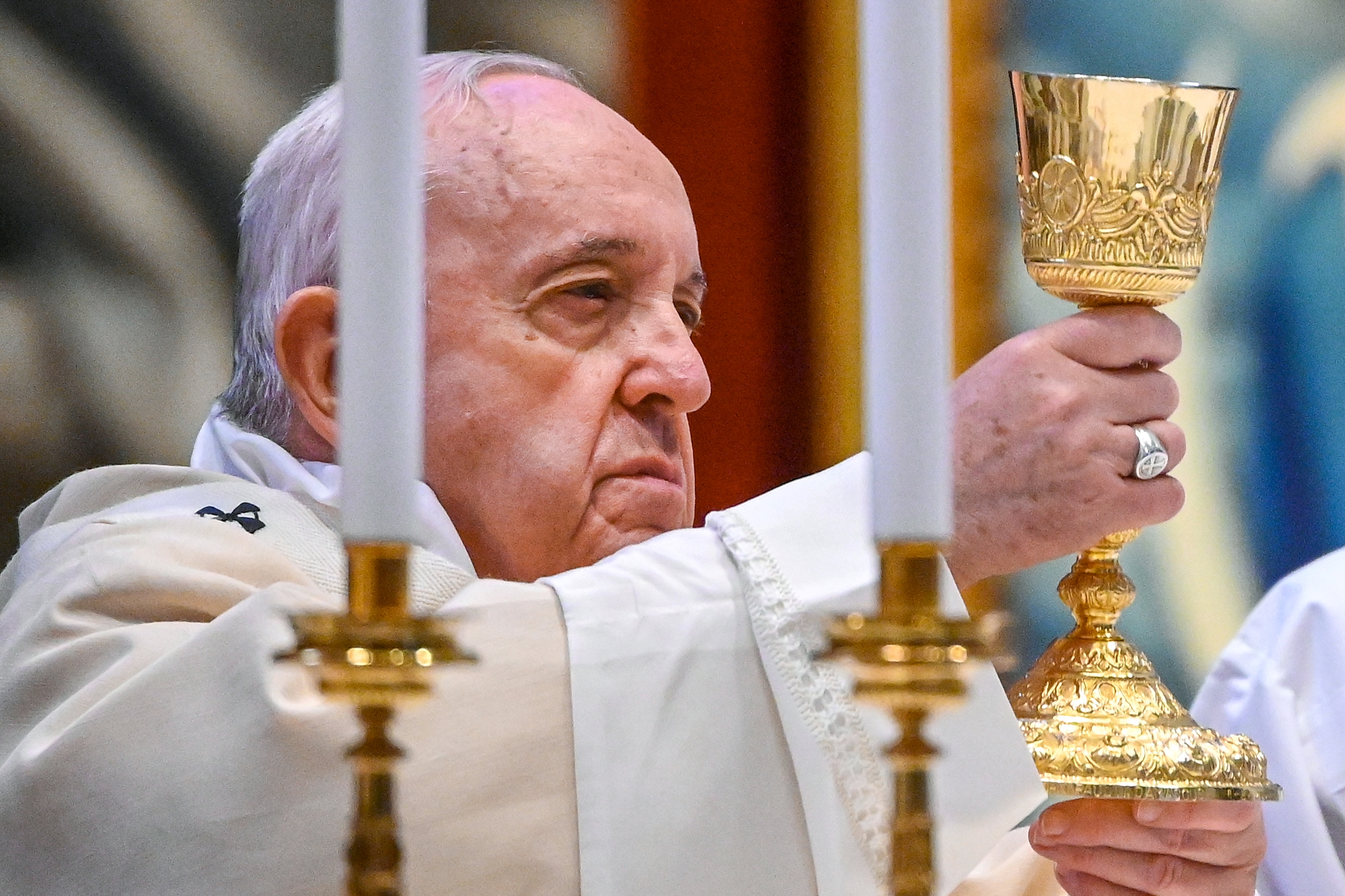 Pope Francis holds the chalice as he celebrates the Eucharist during Mass as part of World Youth Day, at St. Peter's Basilica, at the Vatican, November 22, 2020