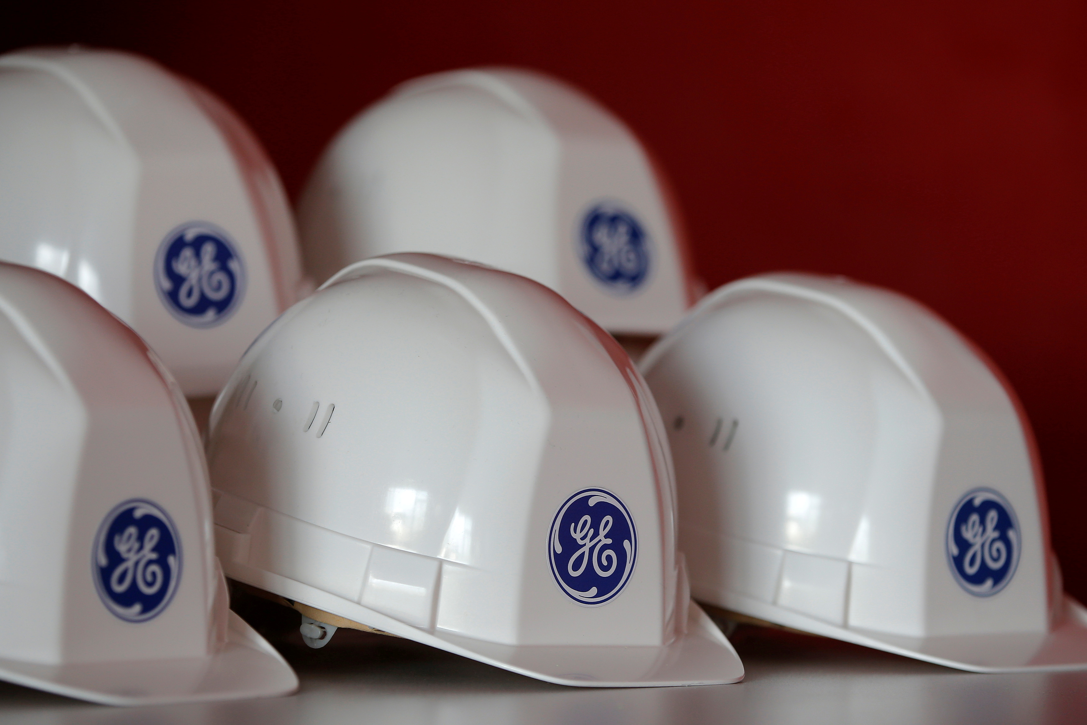 The General Electric logo is pictured on working helmets during a visit at the General Electric offshore wind turbine plant in Montoir-de-Bretagne