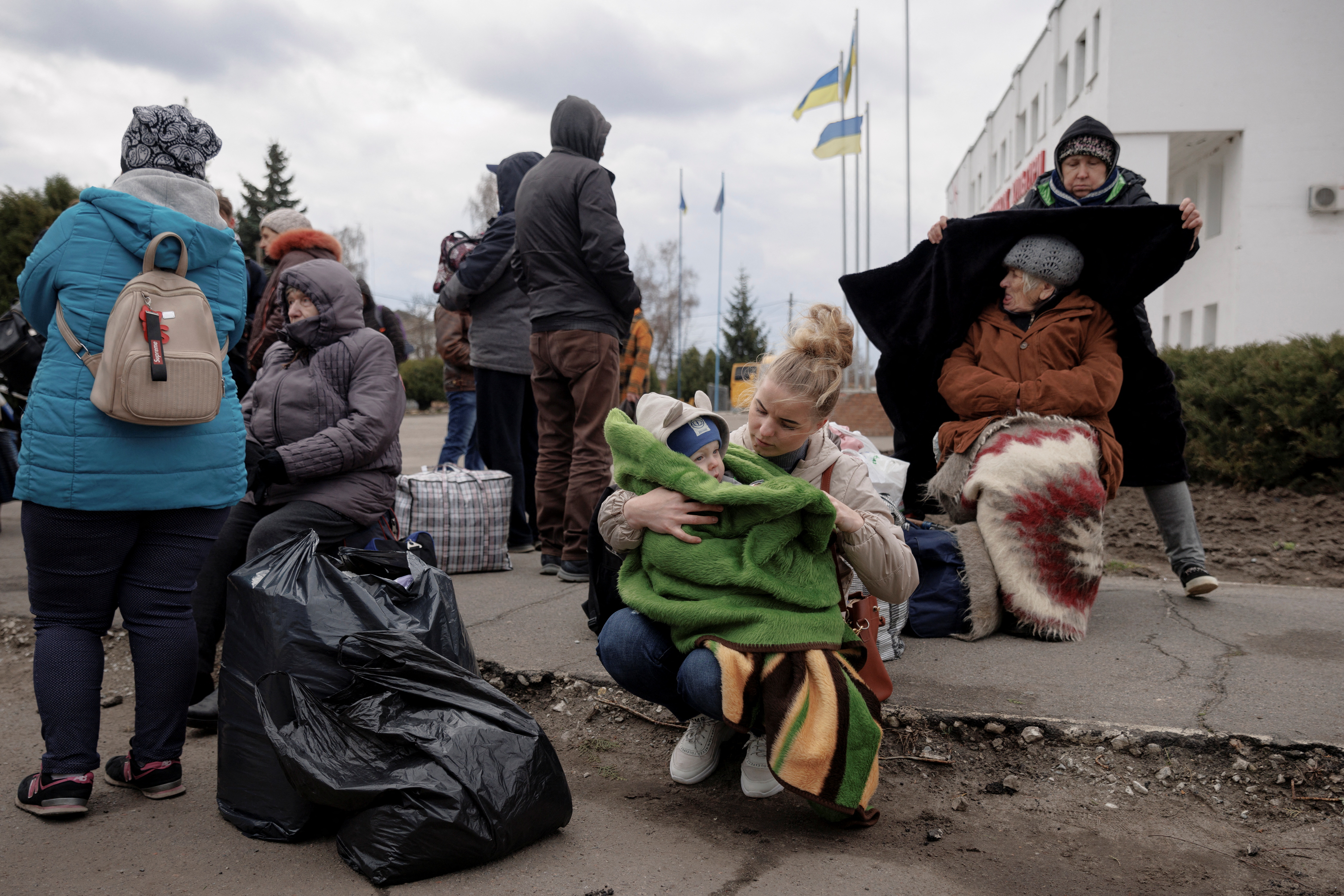 People wait to be evacuated from the heavily shelled town of Derhachi outside Kharkiv