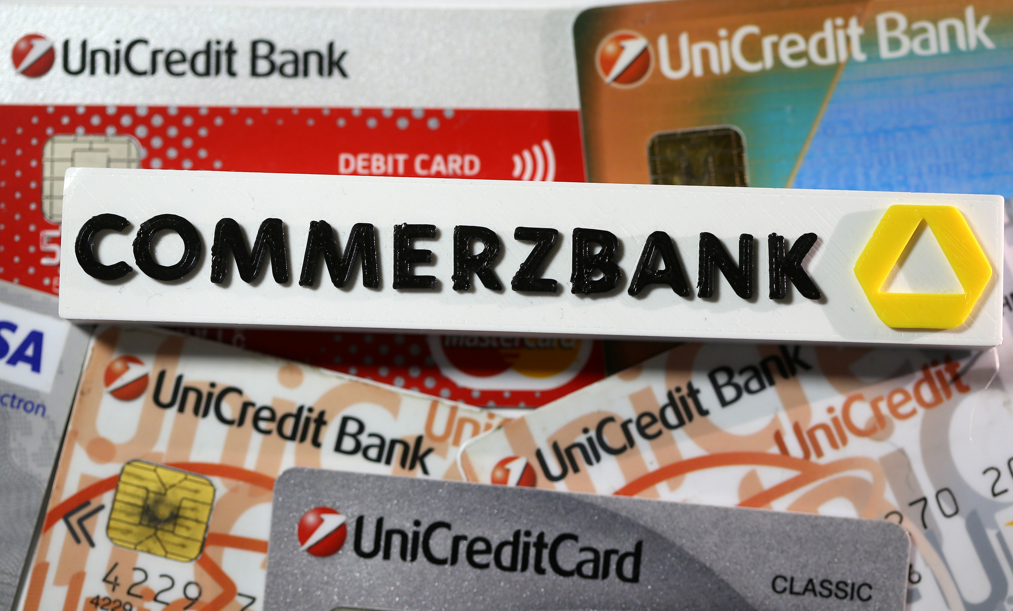 A 3-D printed Commerzbank logo are seen near Unicredit credit cards in this illustration taken