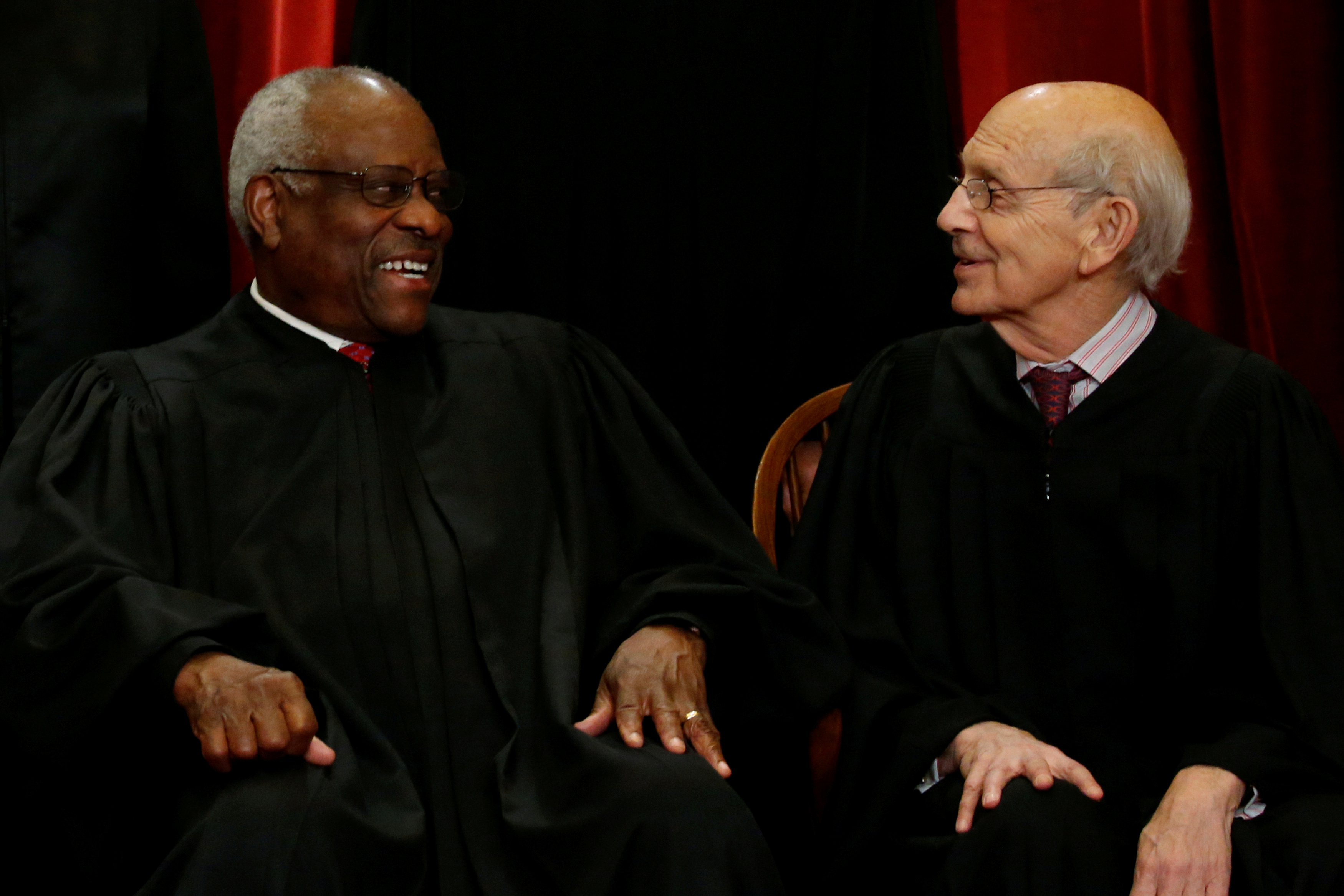 Thomas and Breyer chat during a new U.S. Supreme Court family photo at the Supreme Court building in Washington