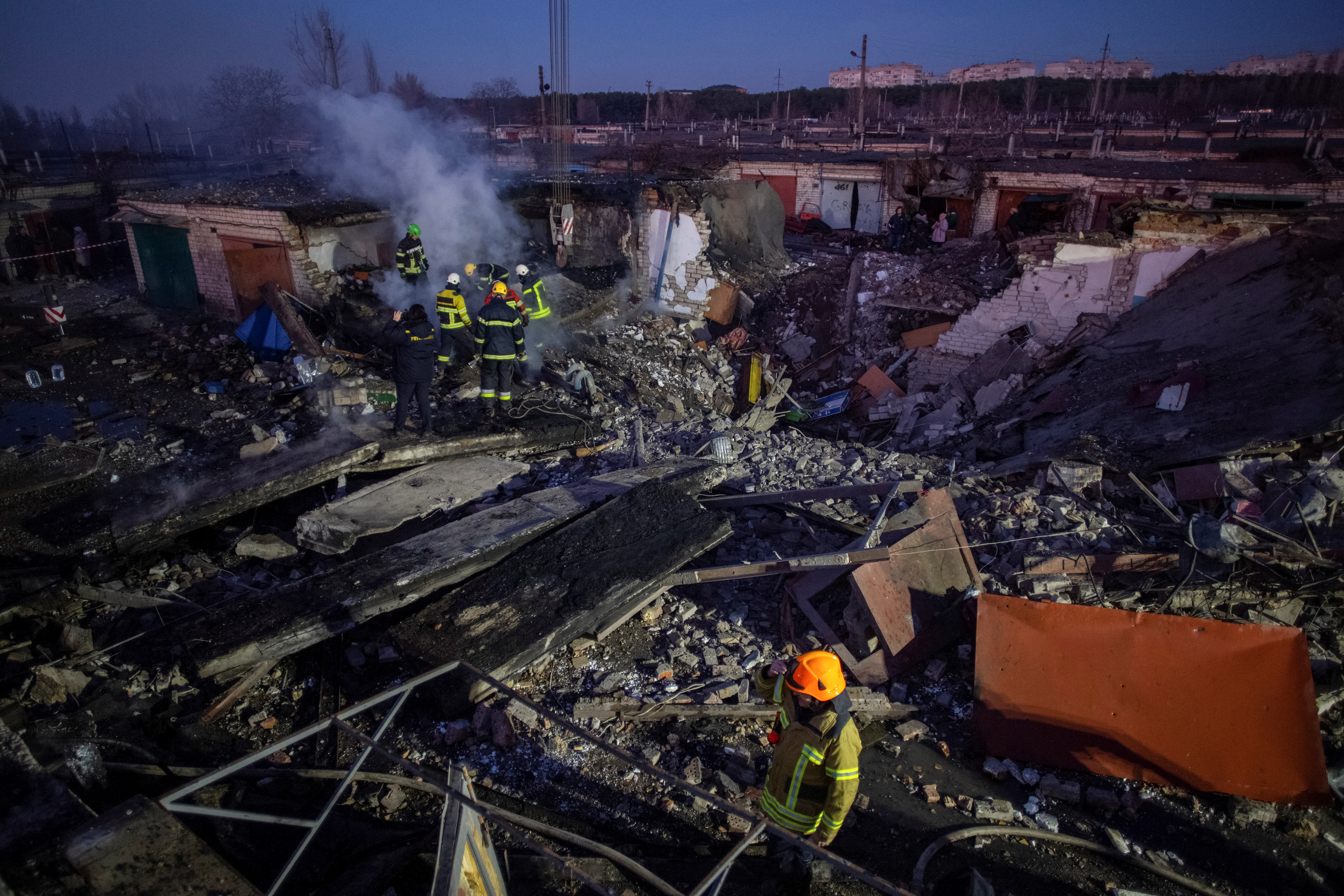 Rescuers work at an area heavily damaged by a Russian missile strike in Mykolaiv