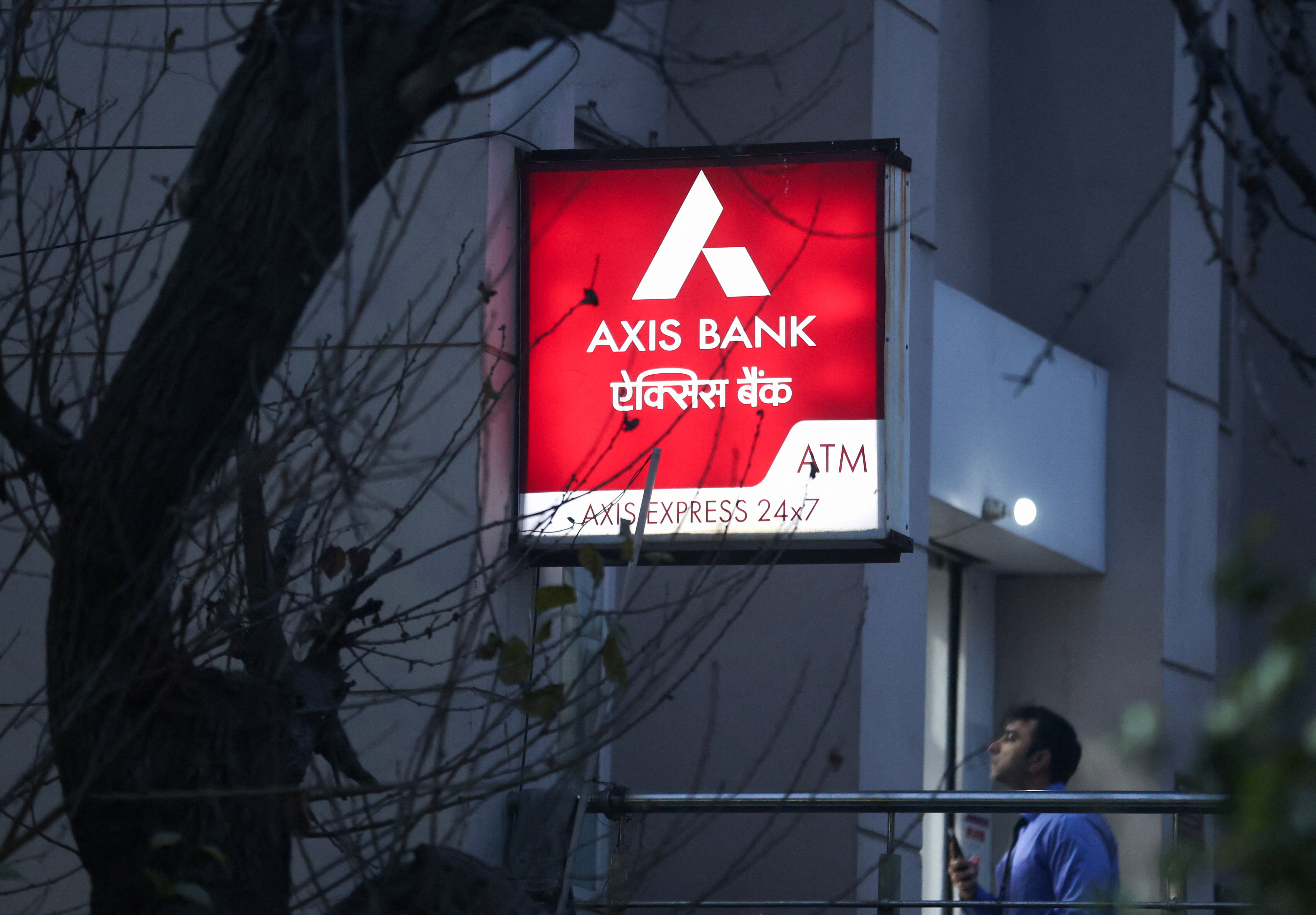 A man enters a branch of Axis Bank in New Delhi