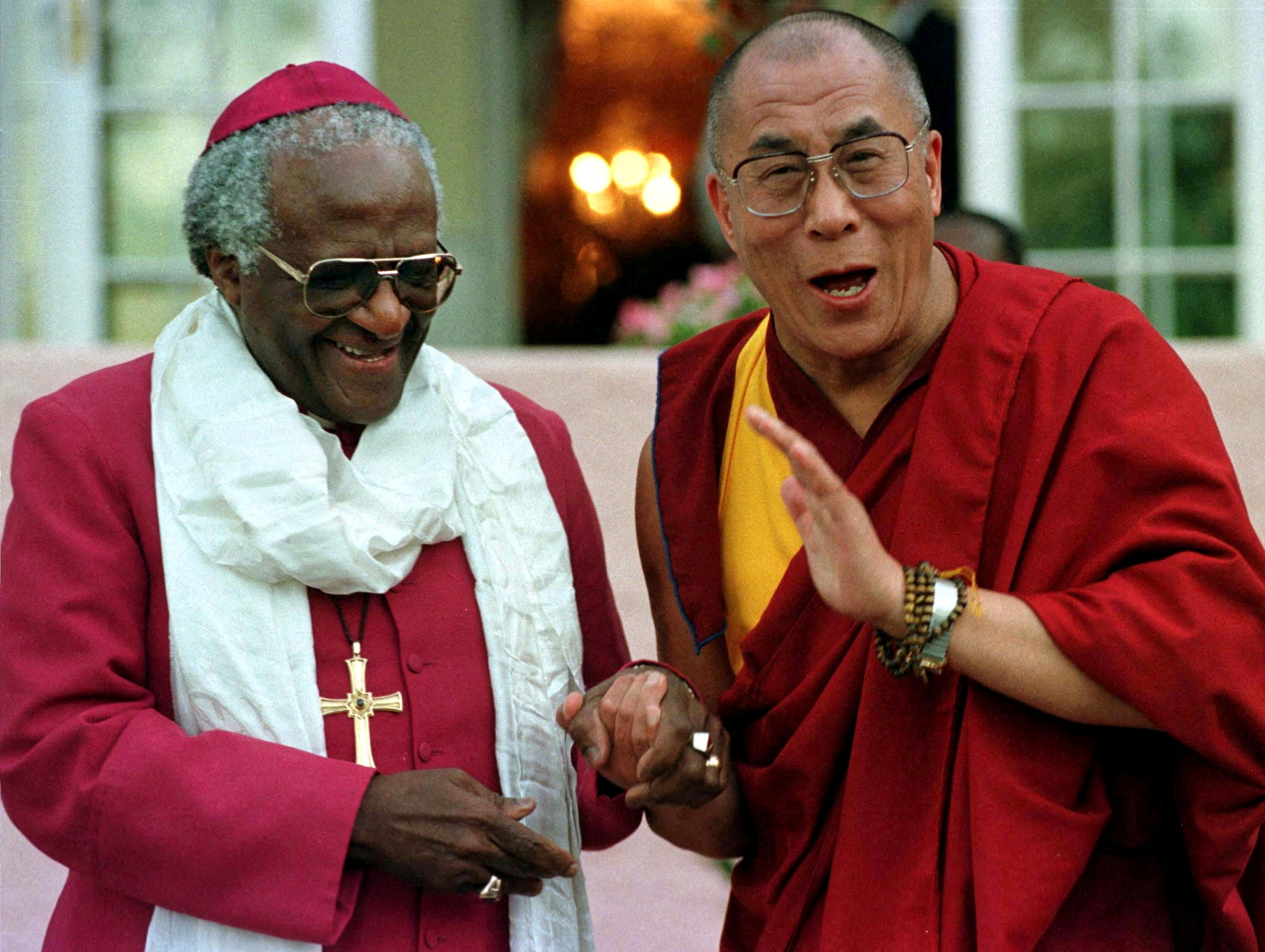 Archbishop Desmond Tutu shares a joke with the Dalai Lama after their meeting, August 21. The Dalai ..