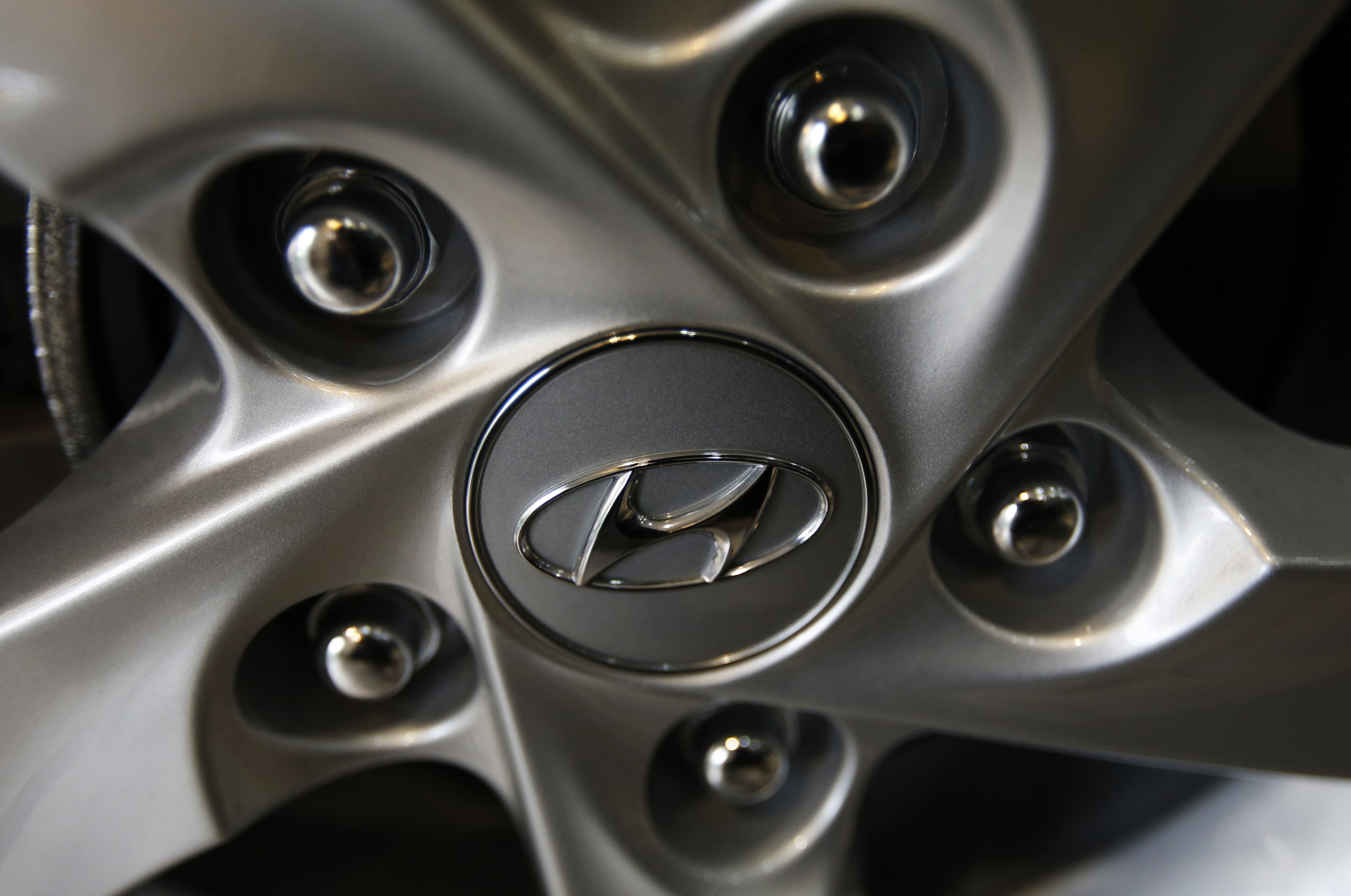 The logo of Hyundai Motor Co. is seen on a wheel of a car at a Hyundai dealership in Seoul