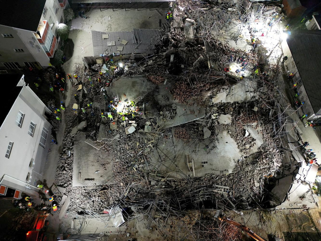 A drone view of the scene of a building collapse where several construction workers are thought to be trapped