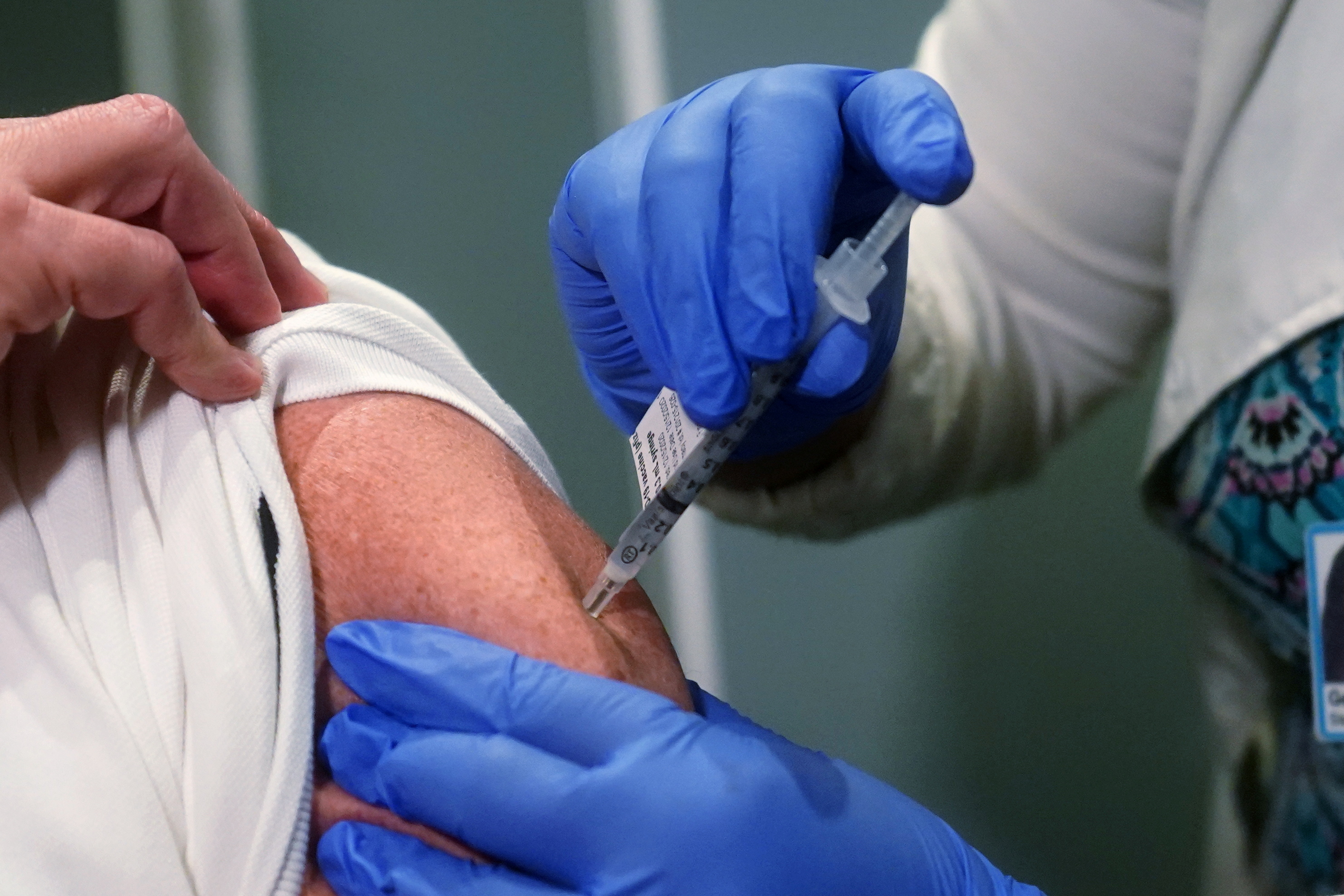 A  nurse receives one of the first vaccinations at Mt. Sinai Hospital from Pfizer-BioNTech, in New York