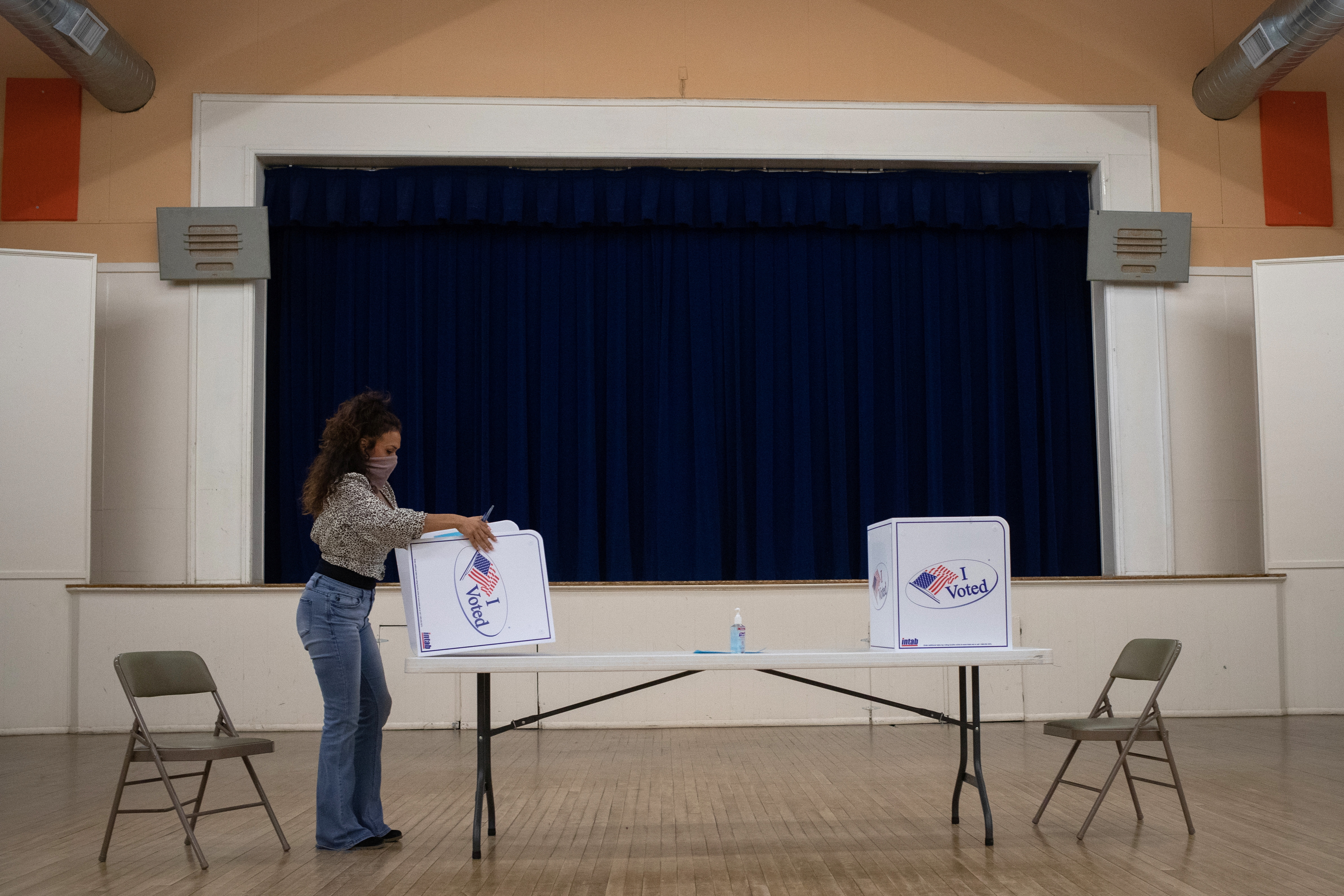 Presidio County election judge folds booth after voting ended for the general election in Marfa, Texas