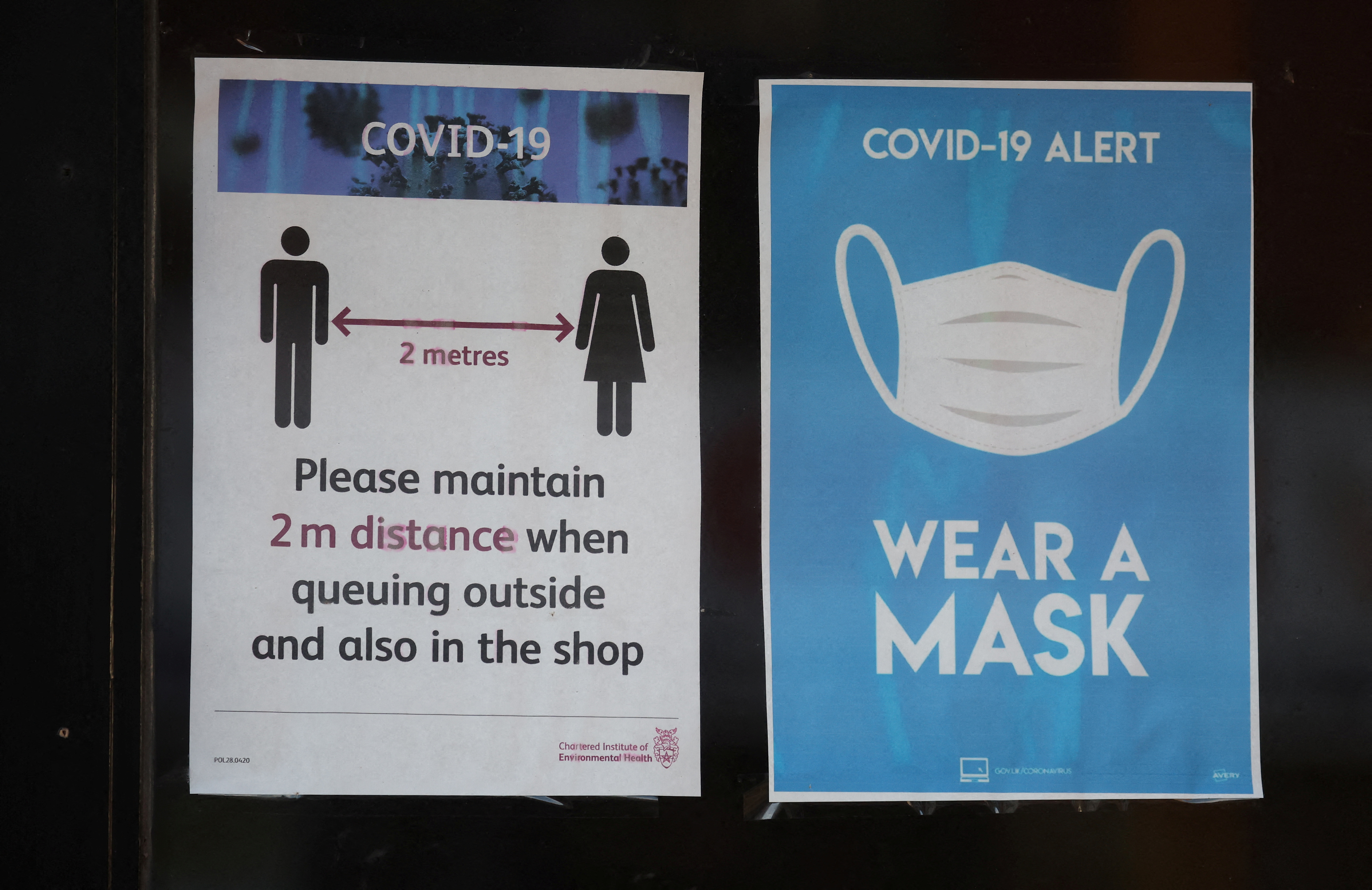 Signage showing health information is seen on the window of a shop in the town centre, amid the coronavirus disease (COVID-19) outbreak in Bolton, Britain