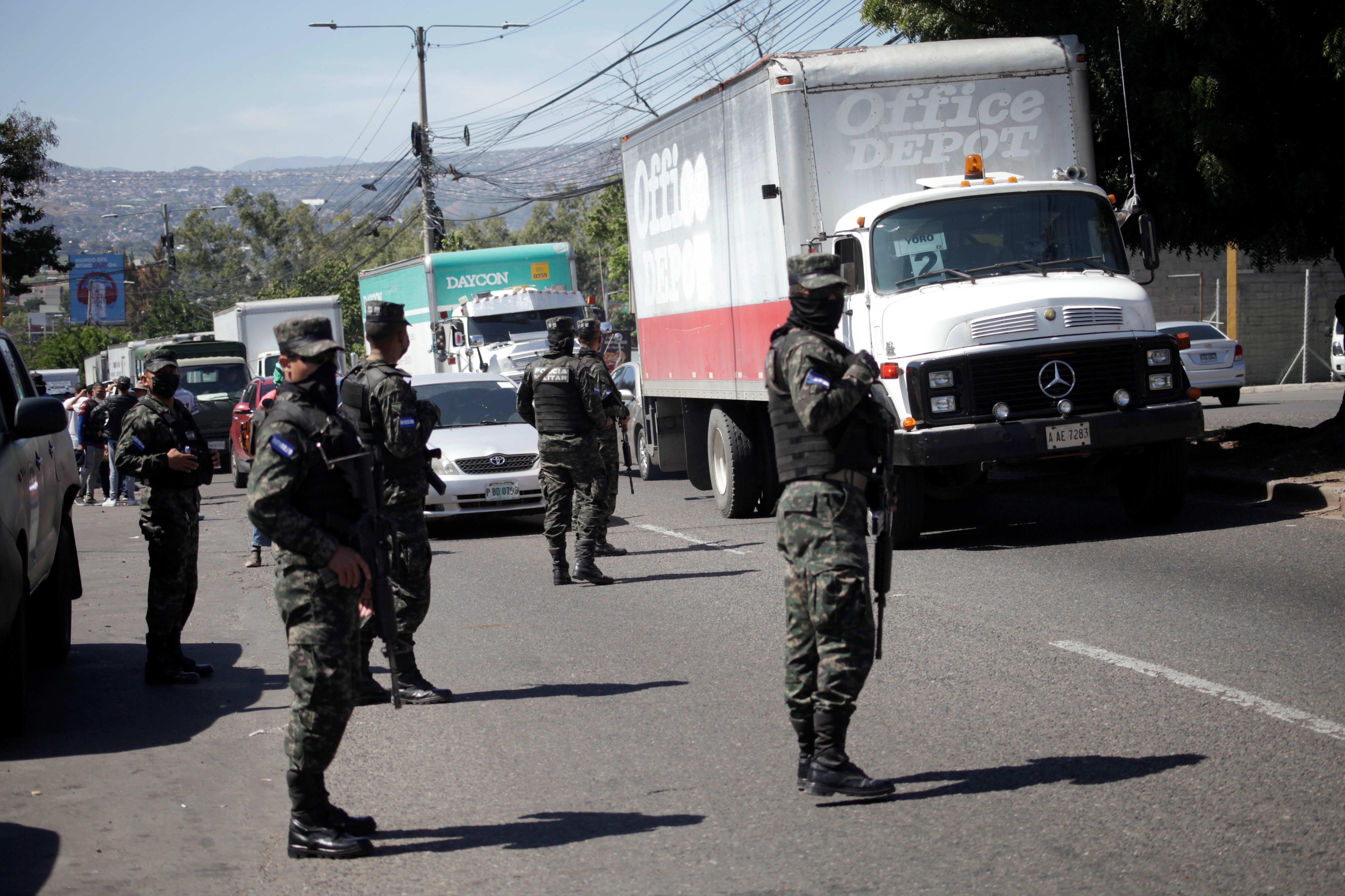 Soldiers control traffic as trucks queue to enter the warehouse where electoral materials are stored, following Sunday's general election in Tegucigalpa, Honduras November 30, 2021. REUTERS/Fredy Rodriguez