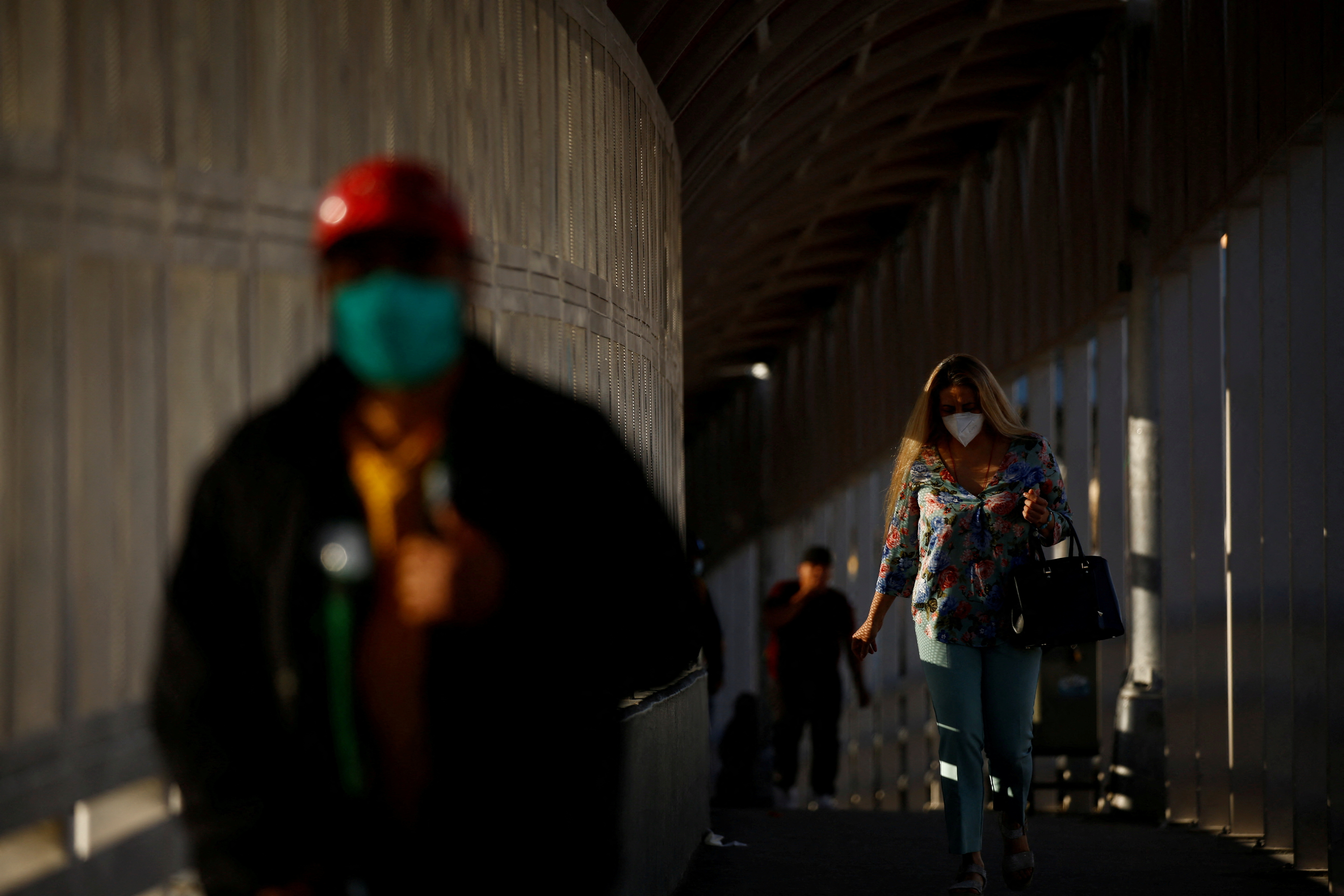 A woman walks towards the U.S. at the Paso del Norte International Border bridge, in Ciudad Juarez