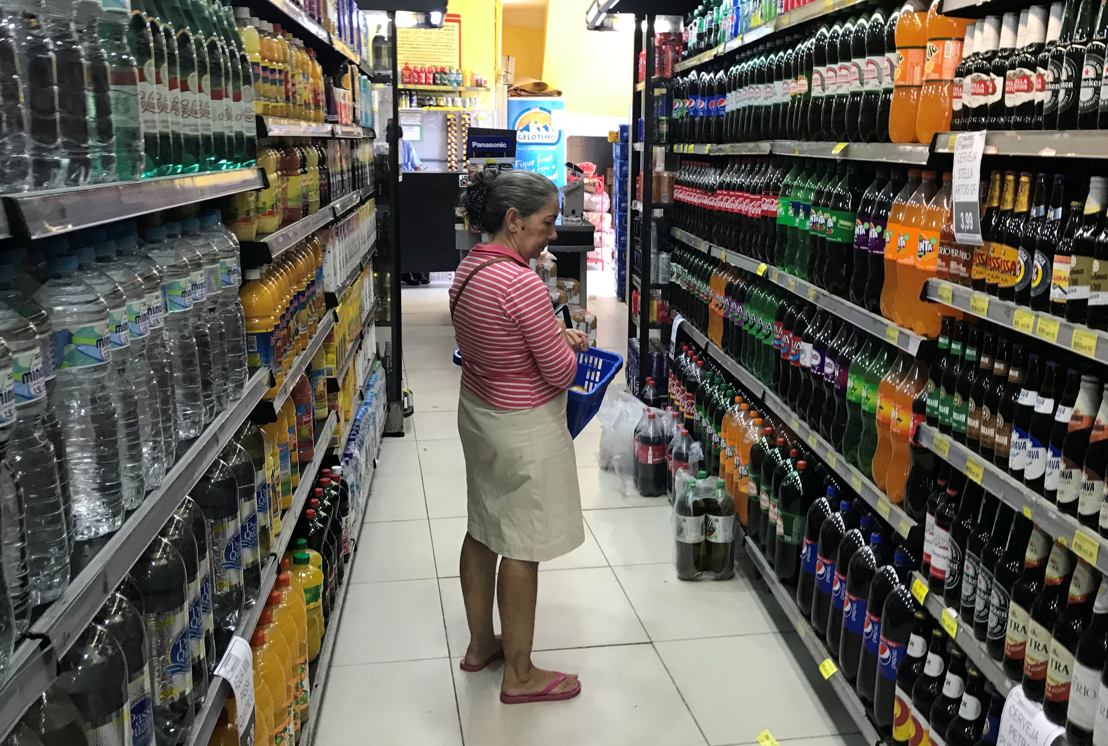 A costumer looks for drinks at a supermarket in Rio de Janeiro
