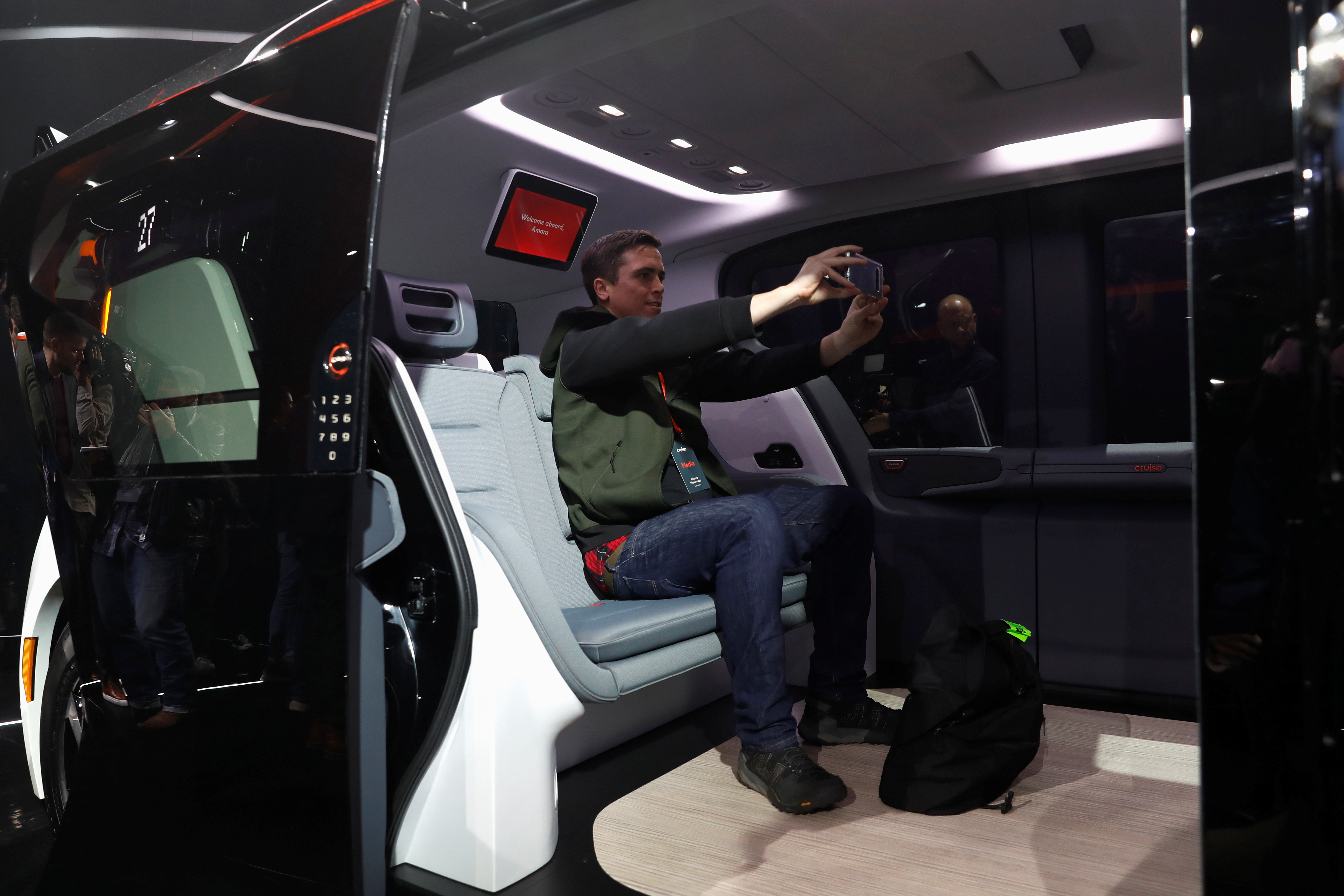 An attendee takes a selfie inside a Cruise Origin autonomous vehicle during its unveiling in San Francisco
