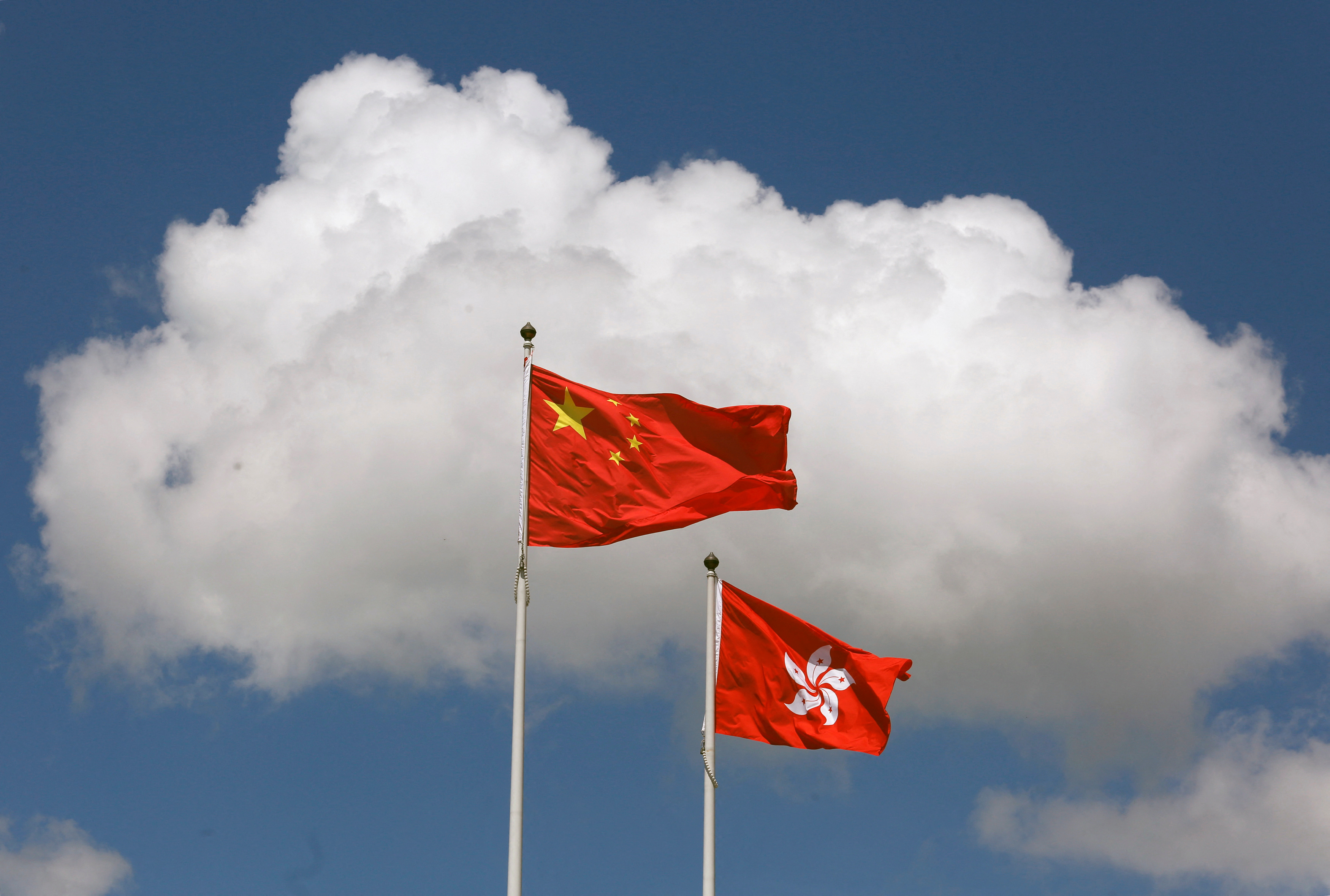 A Chinese national flag and a Hong Kong flag fly outside the Legislative Council in Hong Kong