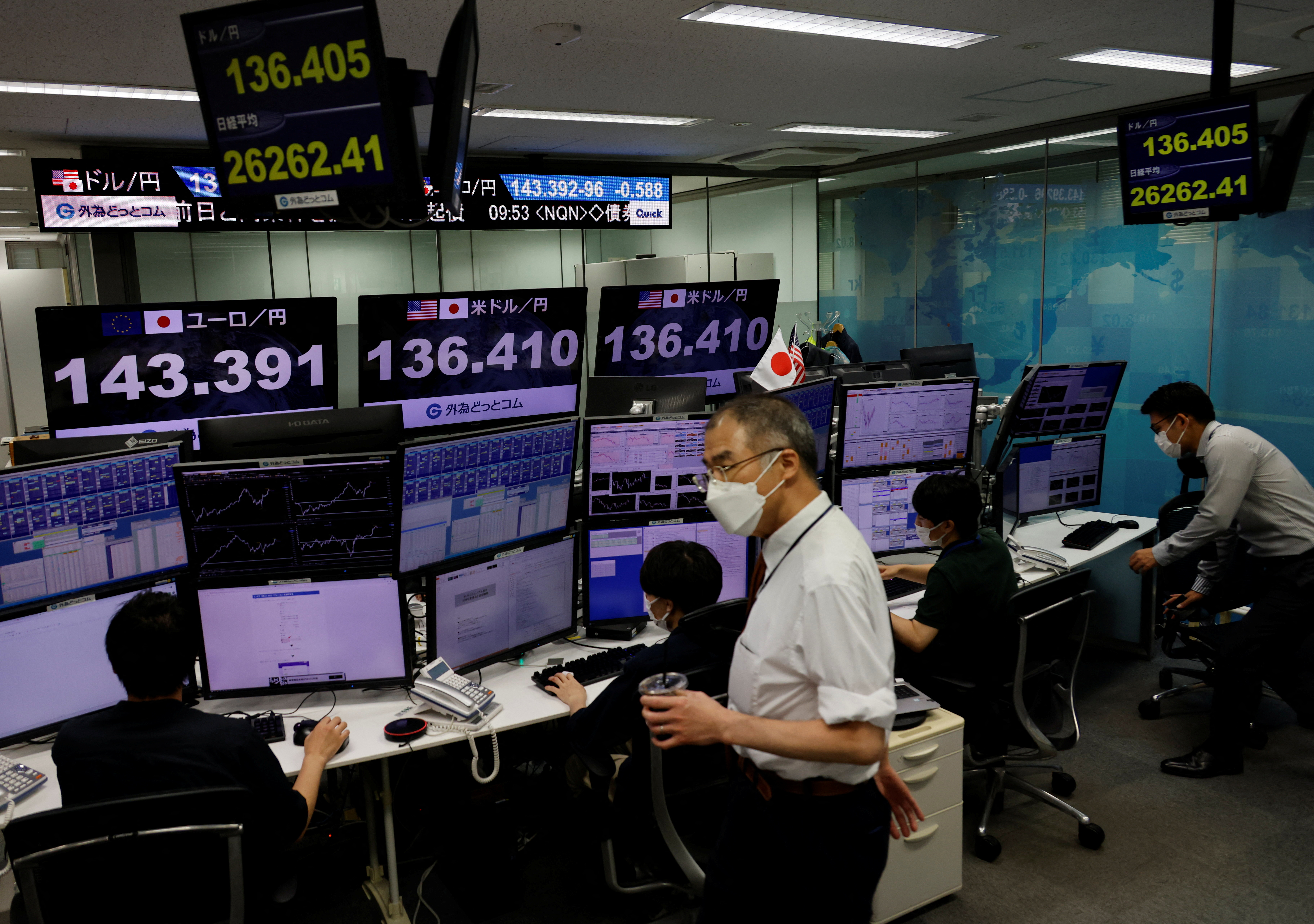 Employees of the foreign exchange trading company Gaitame.com work at its dealing room in Tokyo