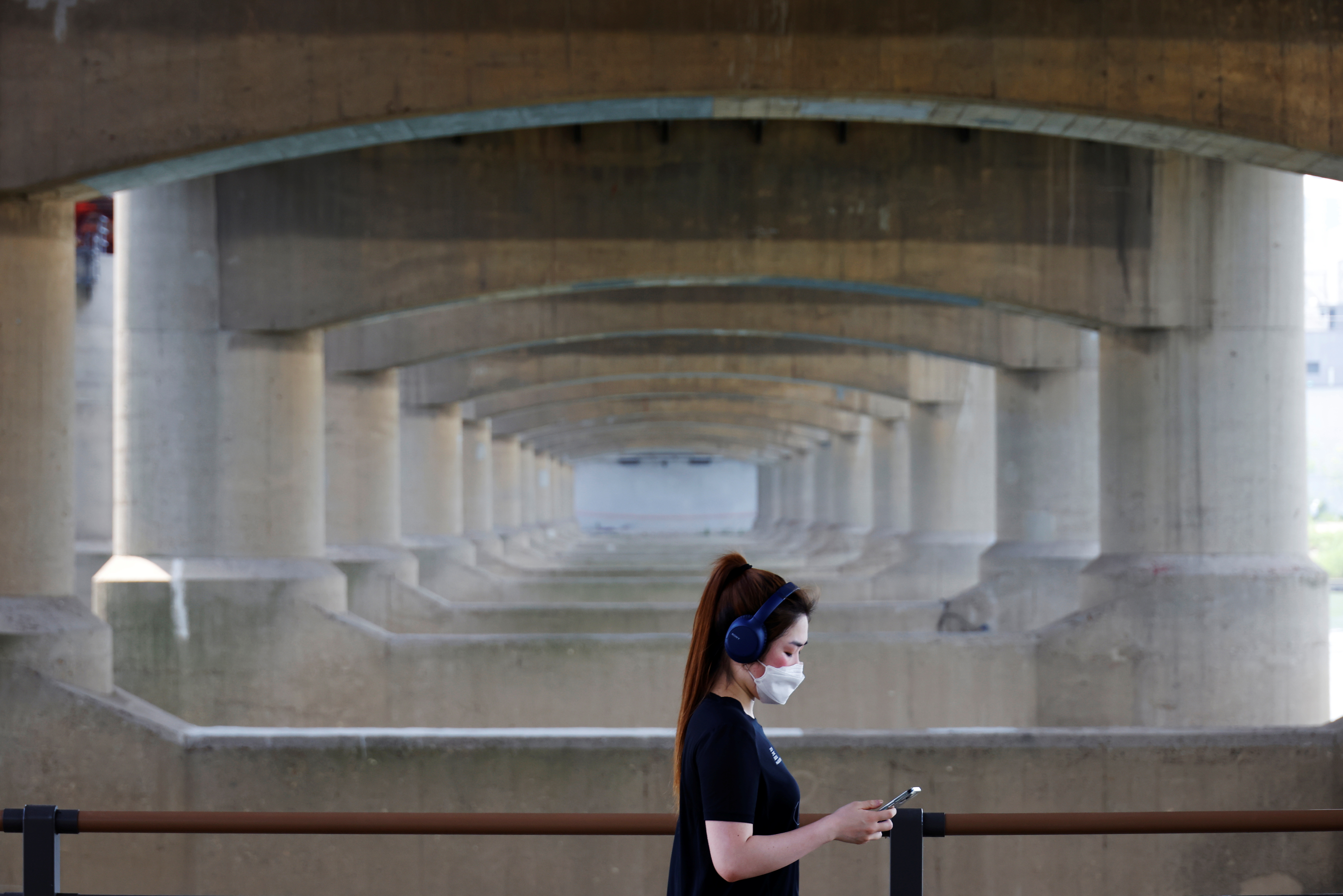 A woman takes a walk at a Han river park amid the coronavirus disease (COVID-19) pandemic, in Seoul