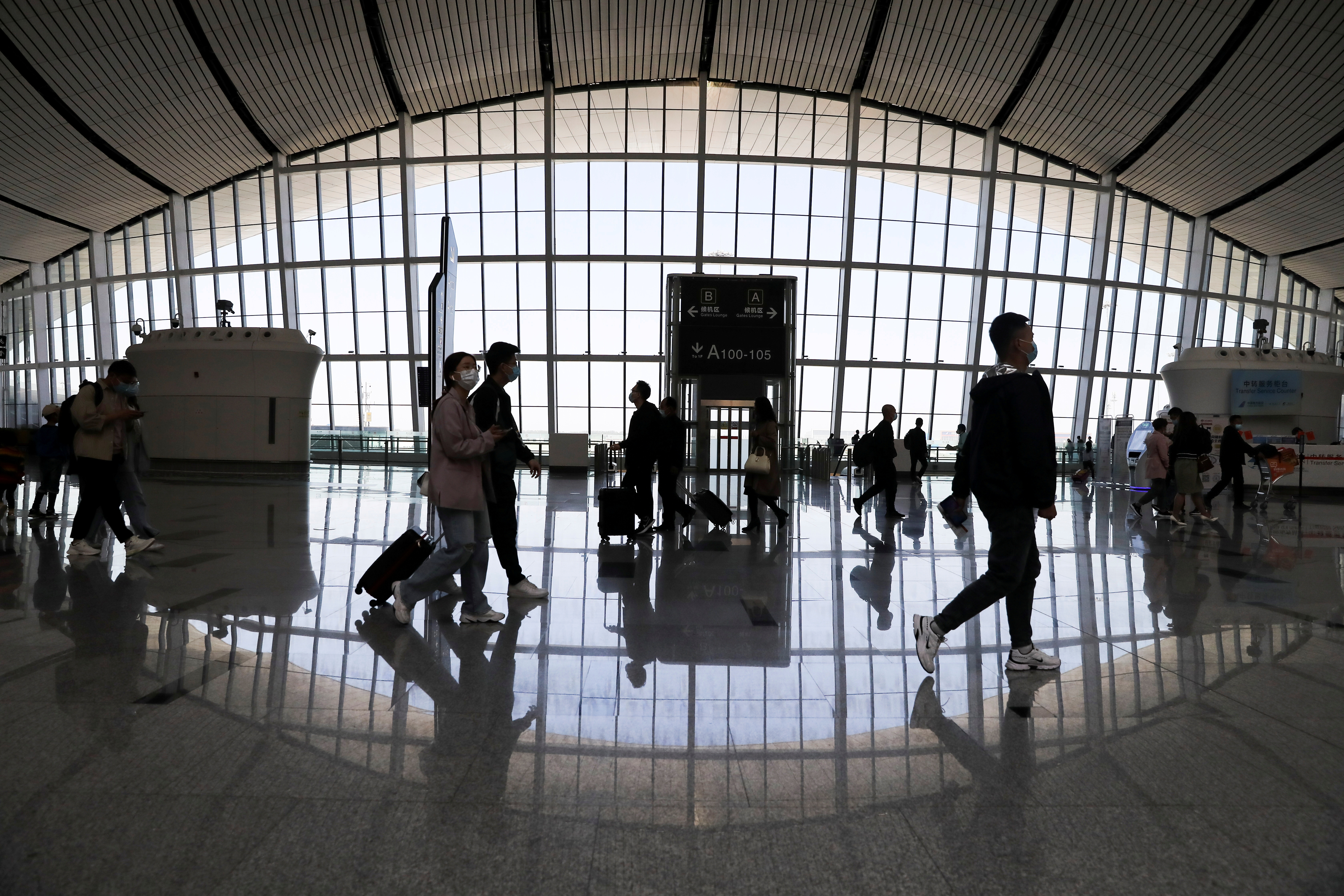 Travellers are seen at the Beijing Daxing International Airport on the first day of Labour Day holiday, in Beijing