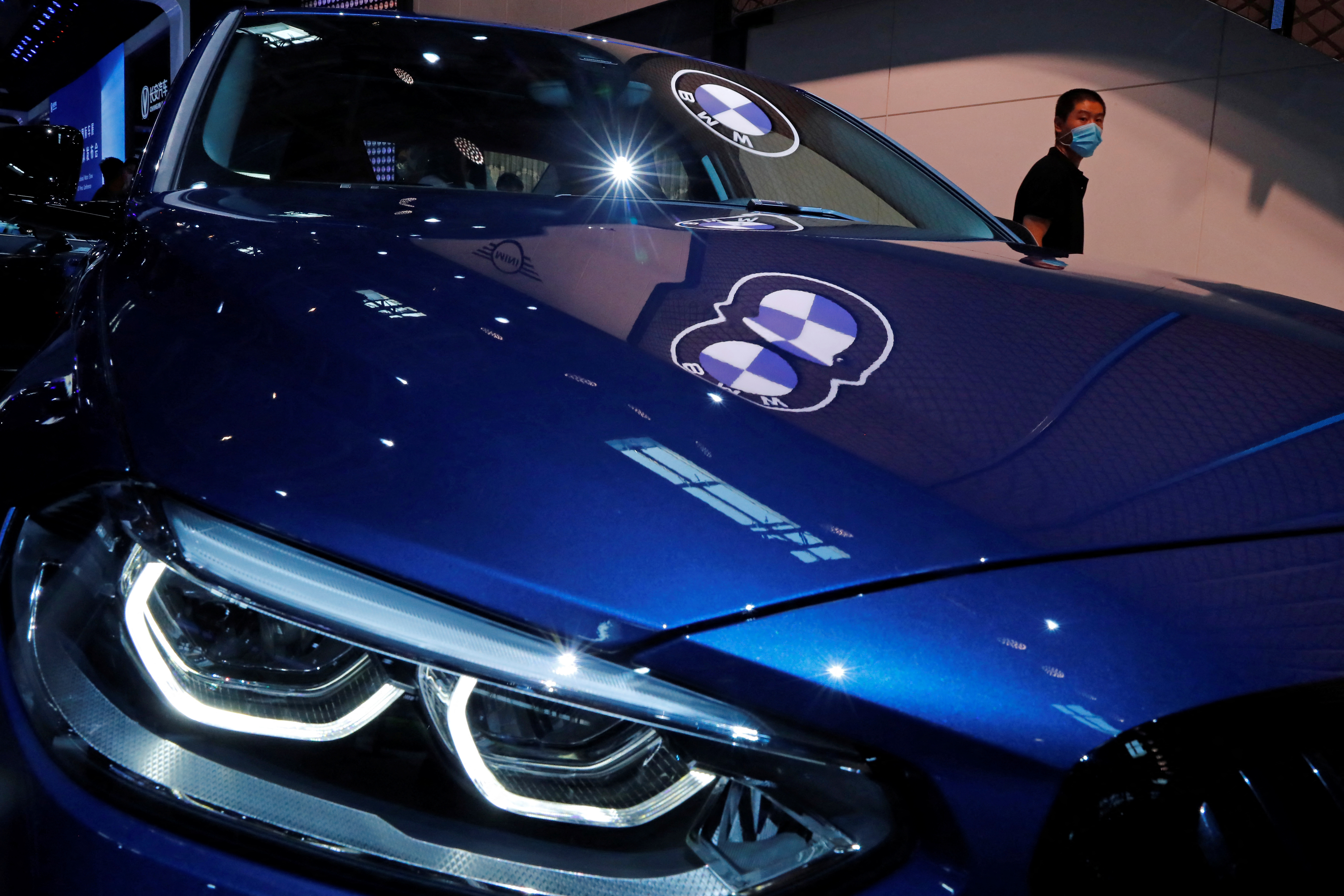 BMW emblems are reflected on the bonnet of a car at the Beijing International Automotive Exhibition, or Auto China show, in Beijing, China September 26, 2020. REUTERS/Thomas Peter