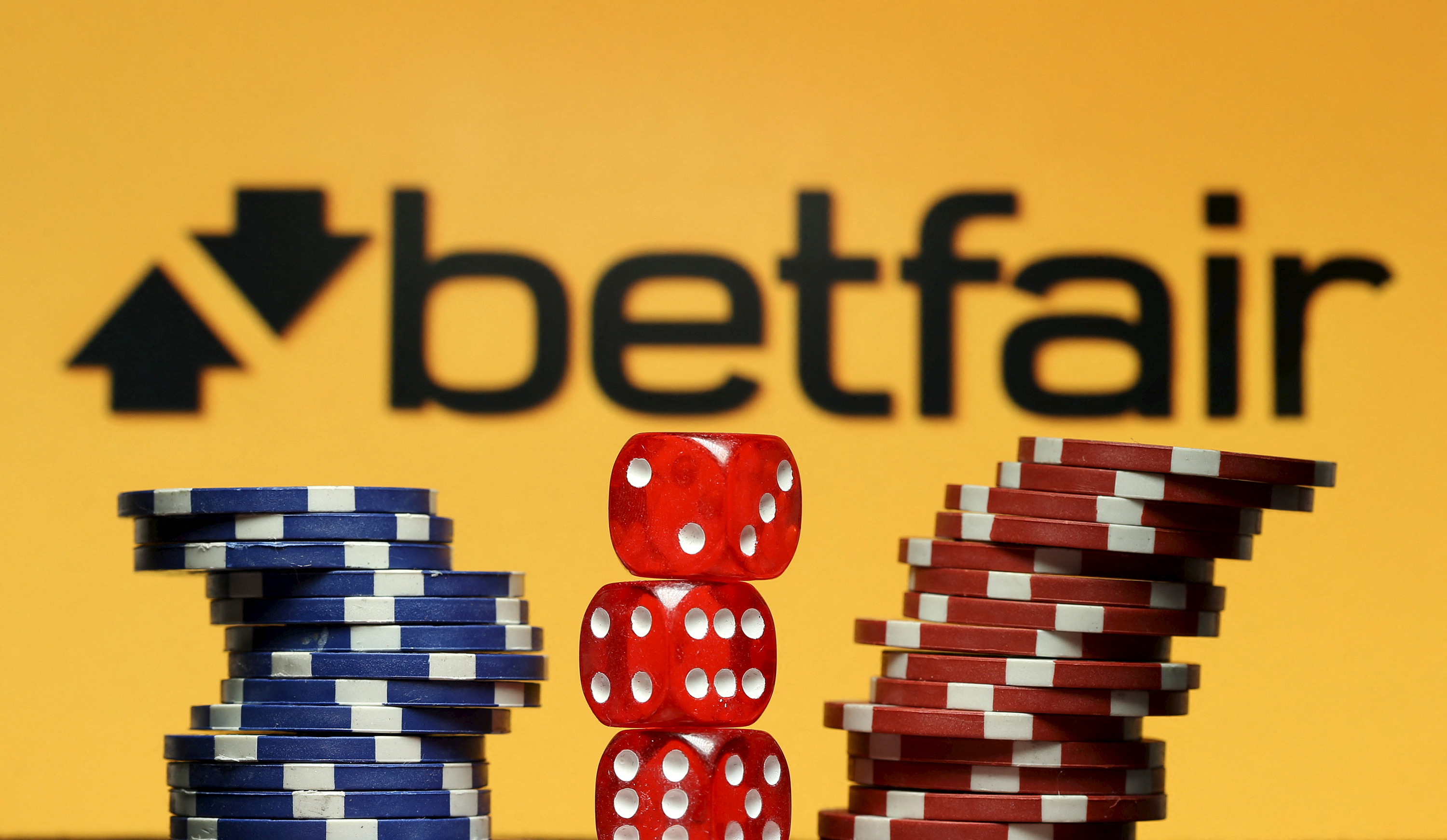 Betfair logo is seen behind gambling dice and chips in this illustration taken in Sarajevo
