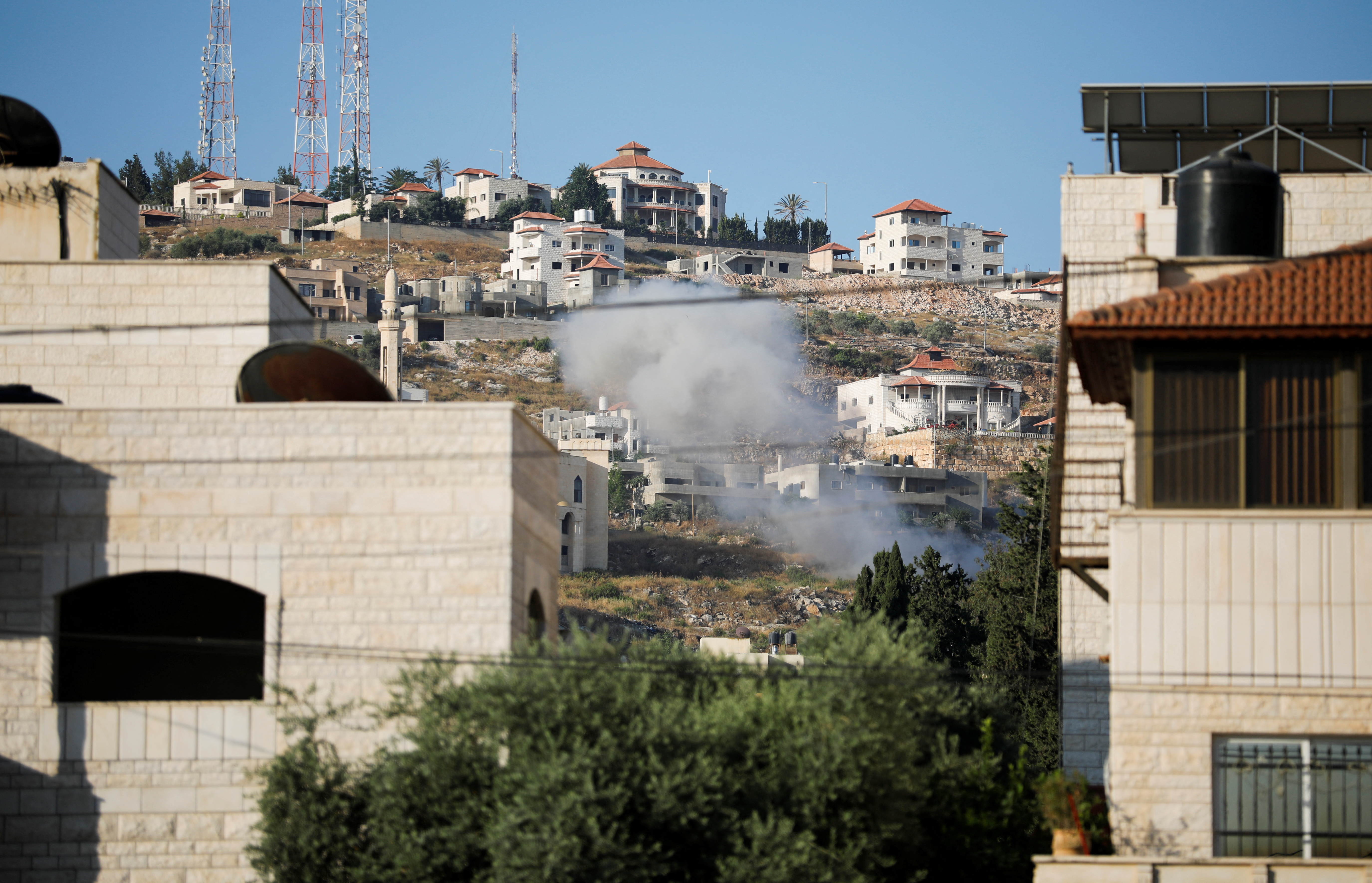 Palestinians clash with Israeli troops during an Israeli raid in Jenin