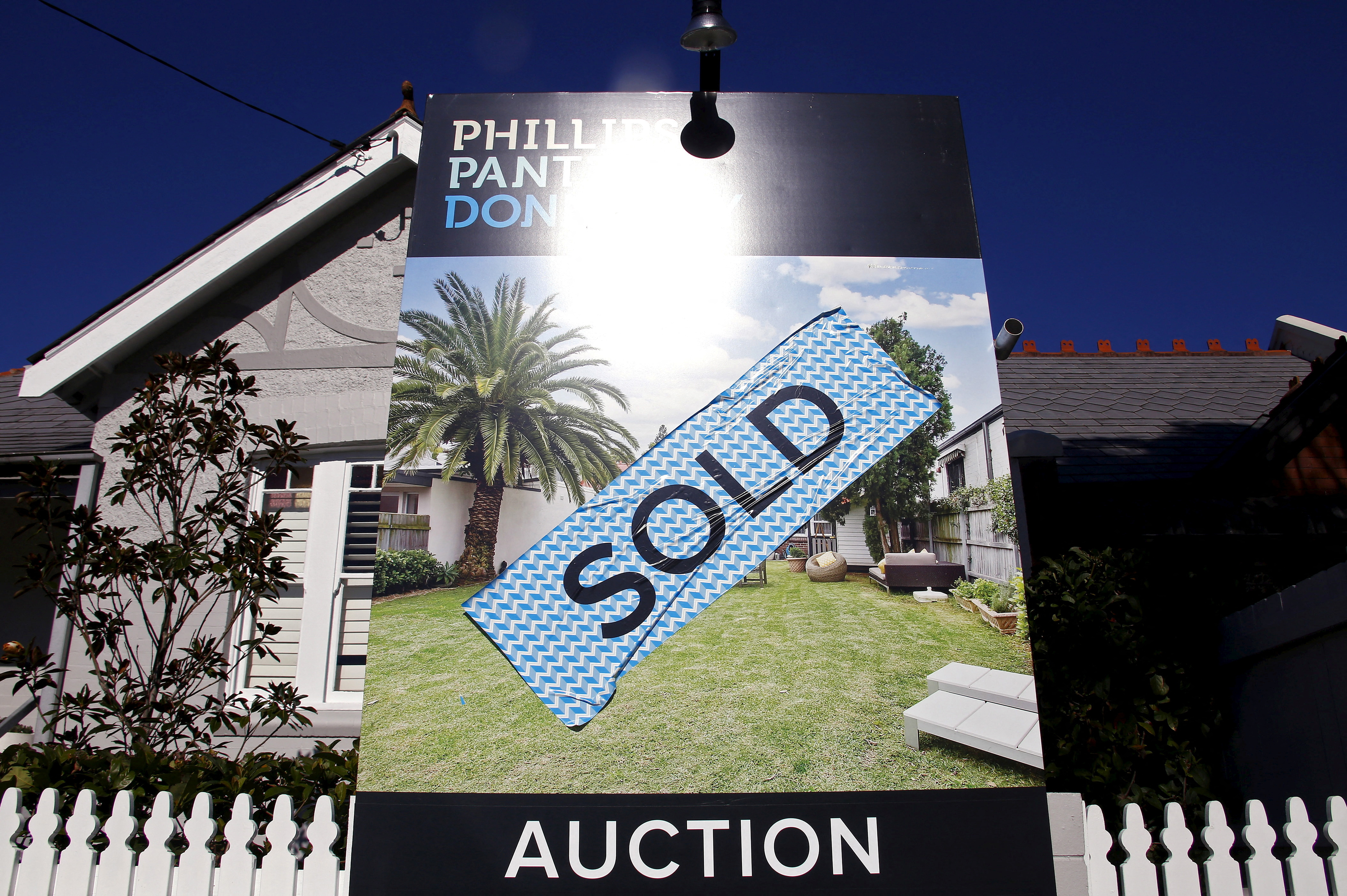 Sign stands at the front of a house after it was sold at an auction in the Sydney suburb of Waverley in Australia