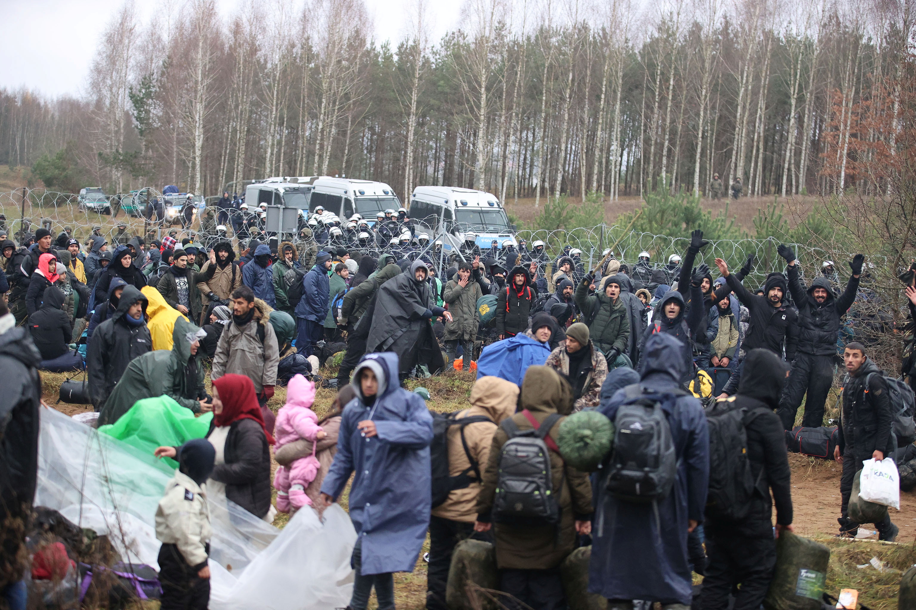 Migrants gather on the Belarusian-Polish border