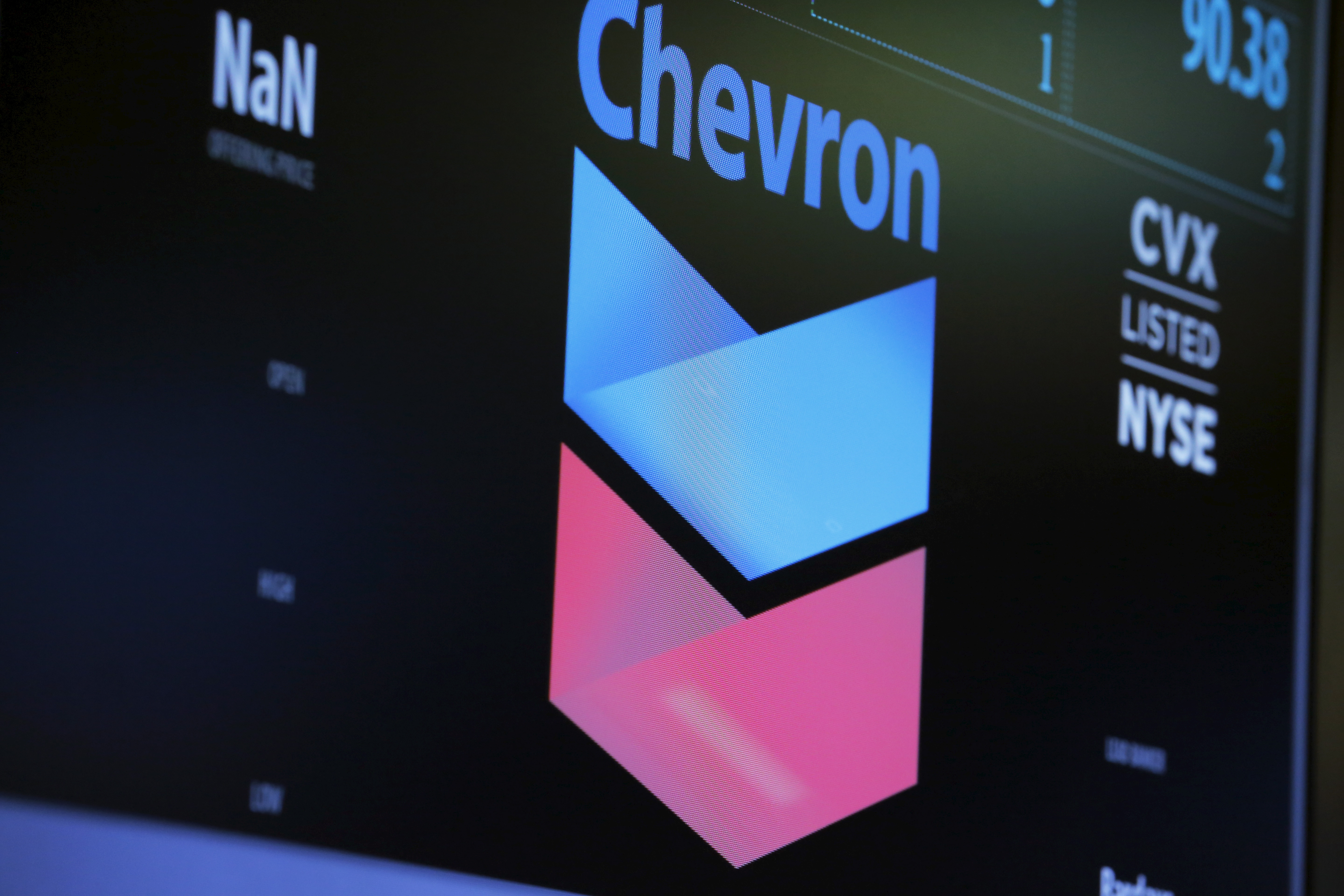 The logo of Chevron is shown on a monitor above the floor of the New York Stock Exchange in New York
