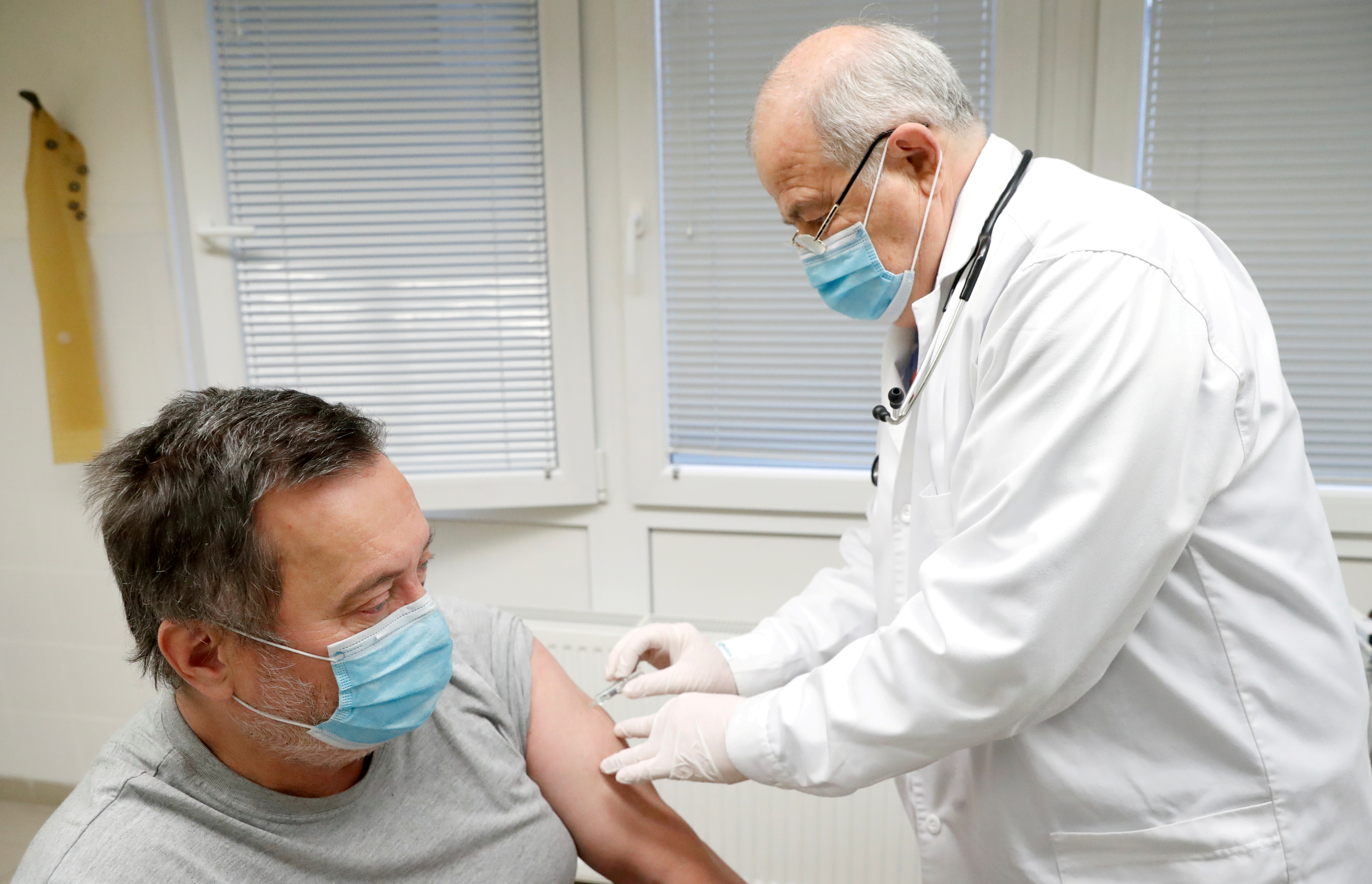 Family doctor Csaba Denes gives a dose of the Sinopharm coronavirus disease (COVID-19) vaccine to a patient, in Budapest, Hungary February 26, 2021.