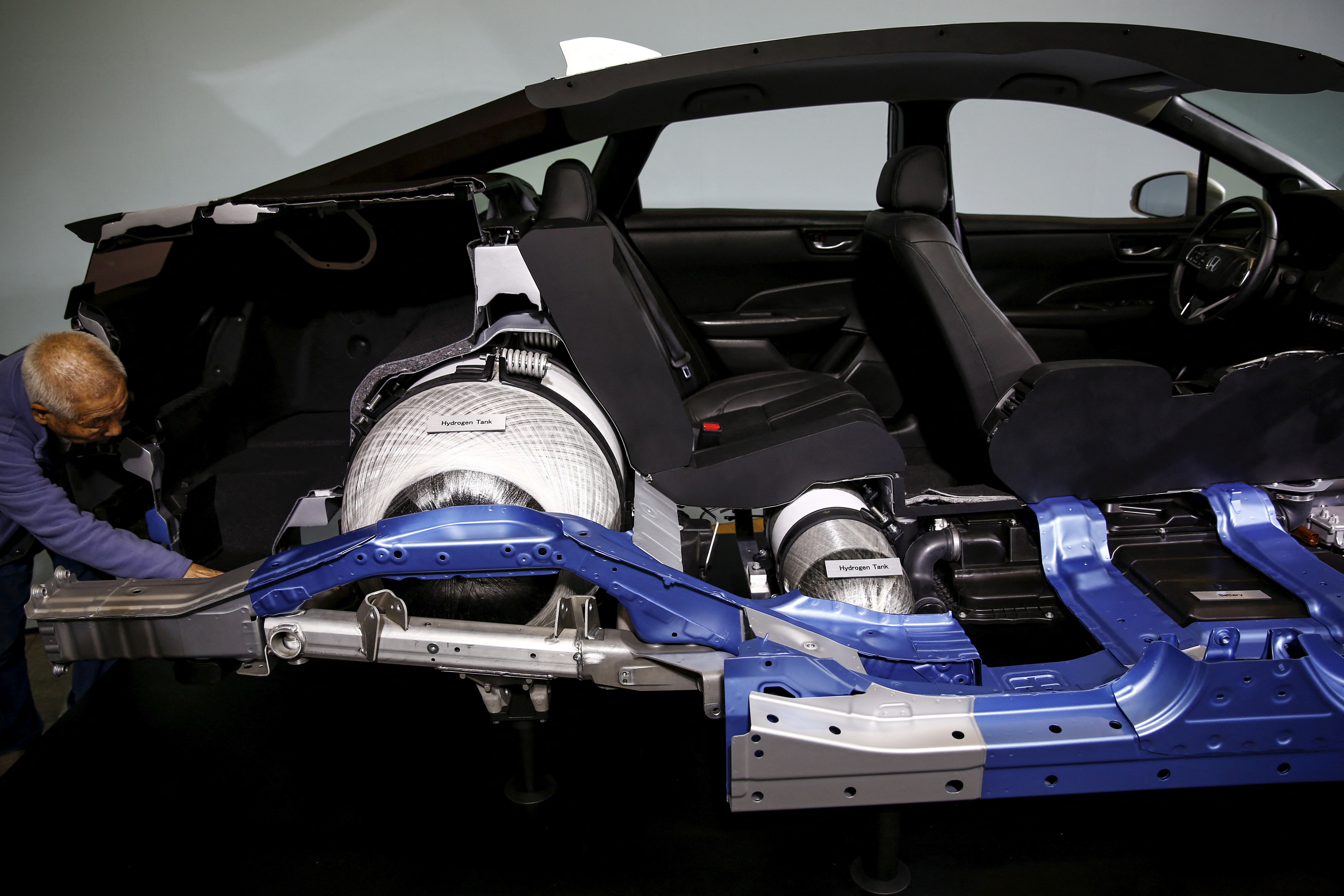 A man looks at the inside of a Honda Clarity, Honda Motor's first mass-market fuel-cell vehicle after its presentation at the company's headquarters in Tokyo