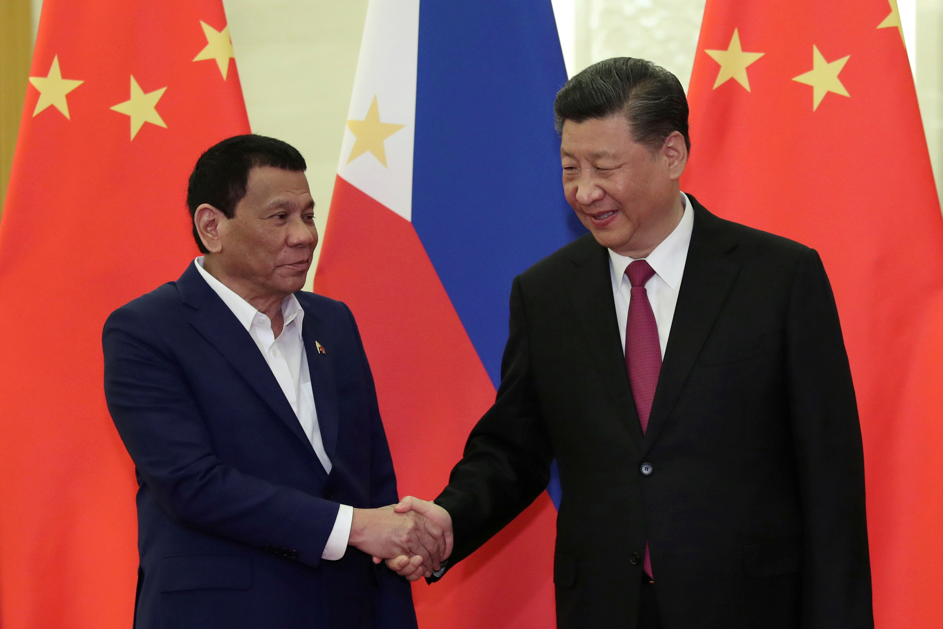Philippine President Rodrigo Duterte shakes hands with Chinese President Xi Jinping, before the meeting at the Great Hall of People in Beijing