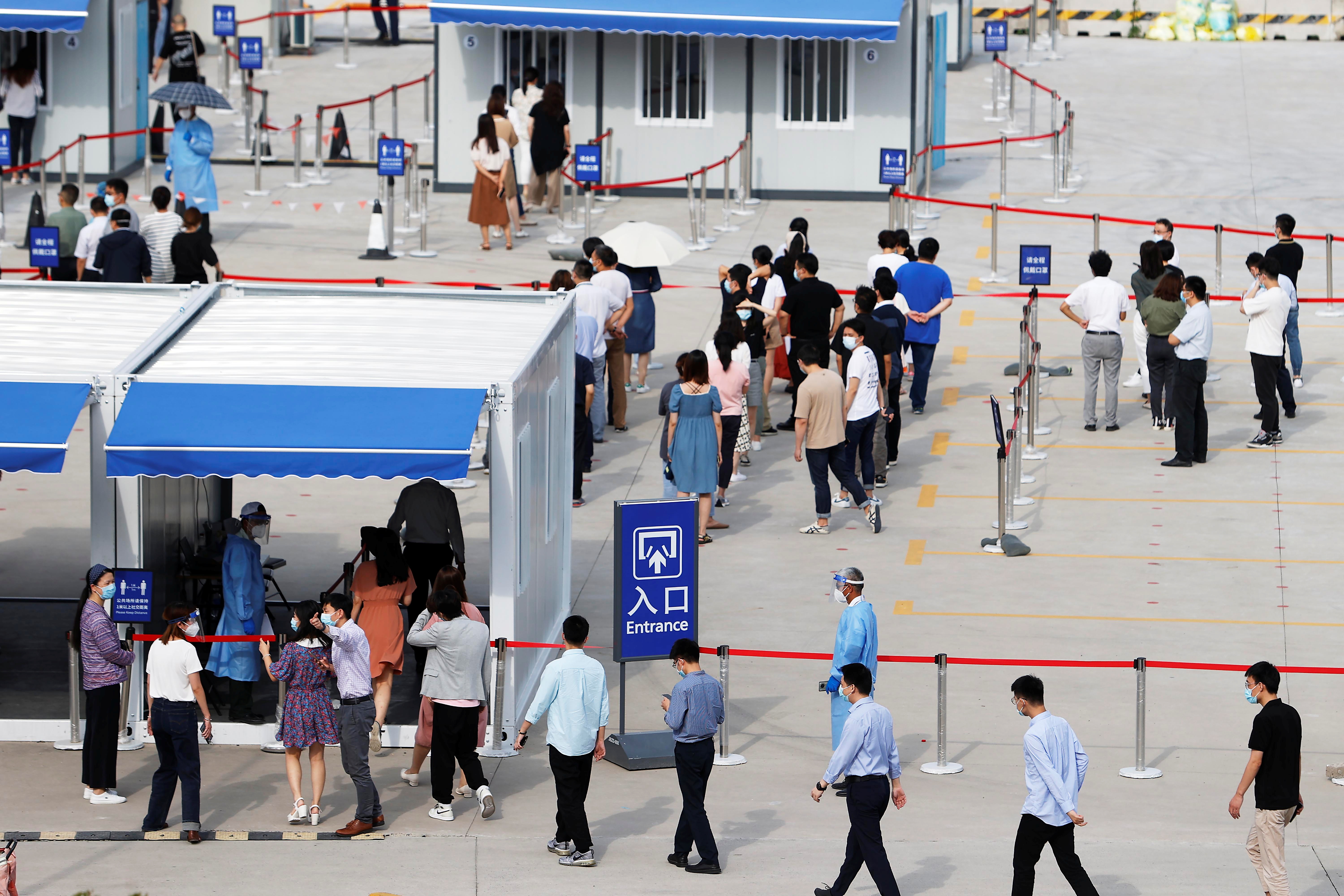 Staff members of Shanghai Pudong International Airport line up for nucleic acid testing in Shanghai
